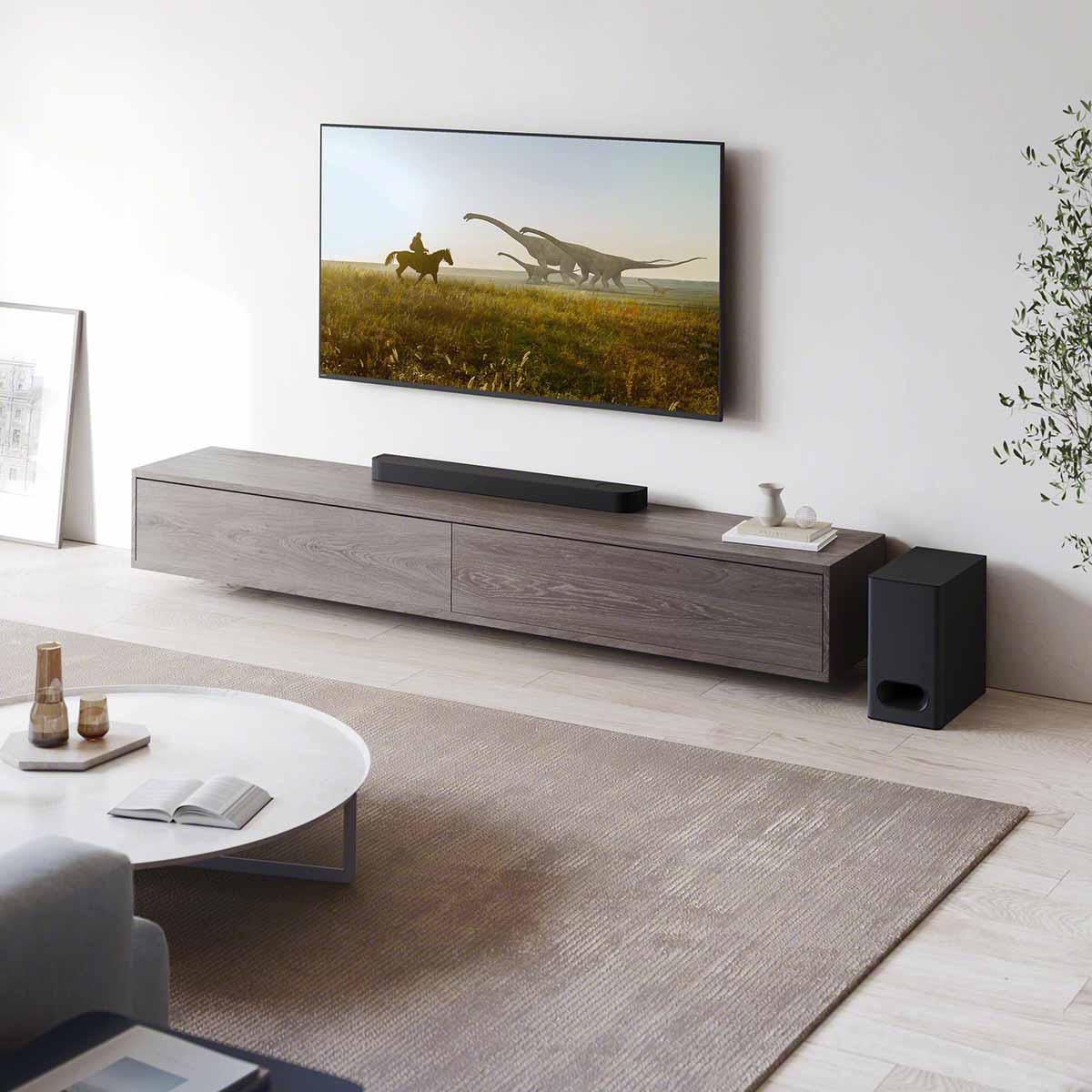 Lifestyle shot of Sony HT-B600 BRAVIA Theater Bar 6 3.1.2ch Soundbar with Wireless Subwoofer - bar on cabinet with subwoofer on ground to right