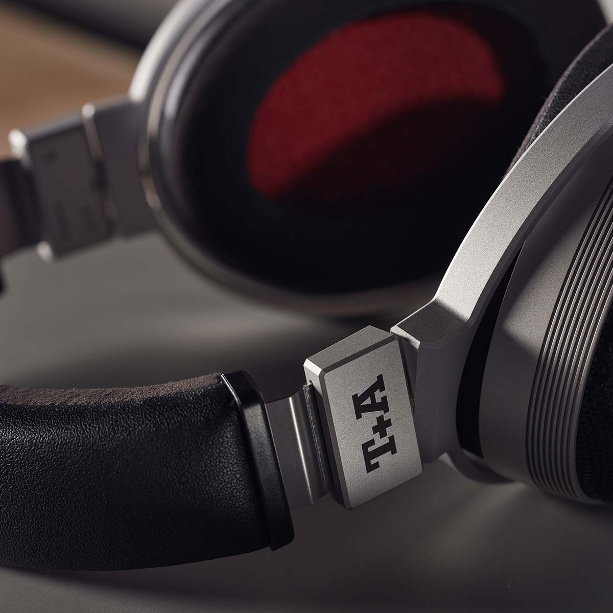 T+A Solitaire P High Performance Open-Back Planar Magnetostatic Headphones - lifestyle shot detail of T+A logo