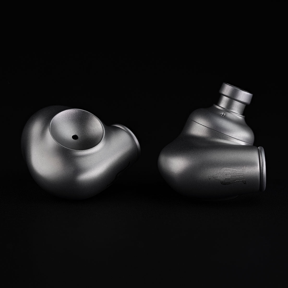 Meze Audio ASTRU Single Dynamic Driver In-Ear Monitors - artistic photo of both earbuds on black background