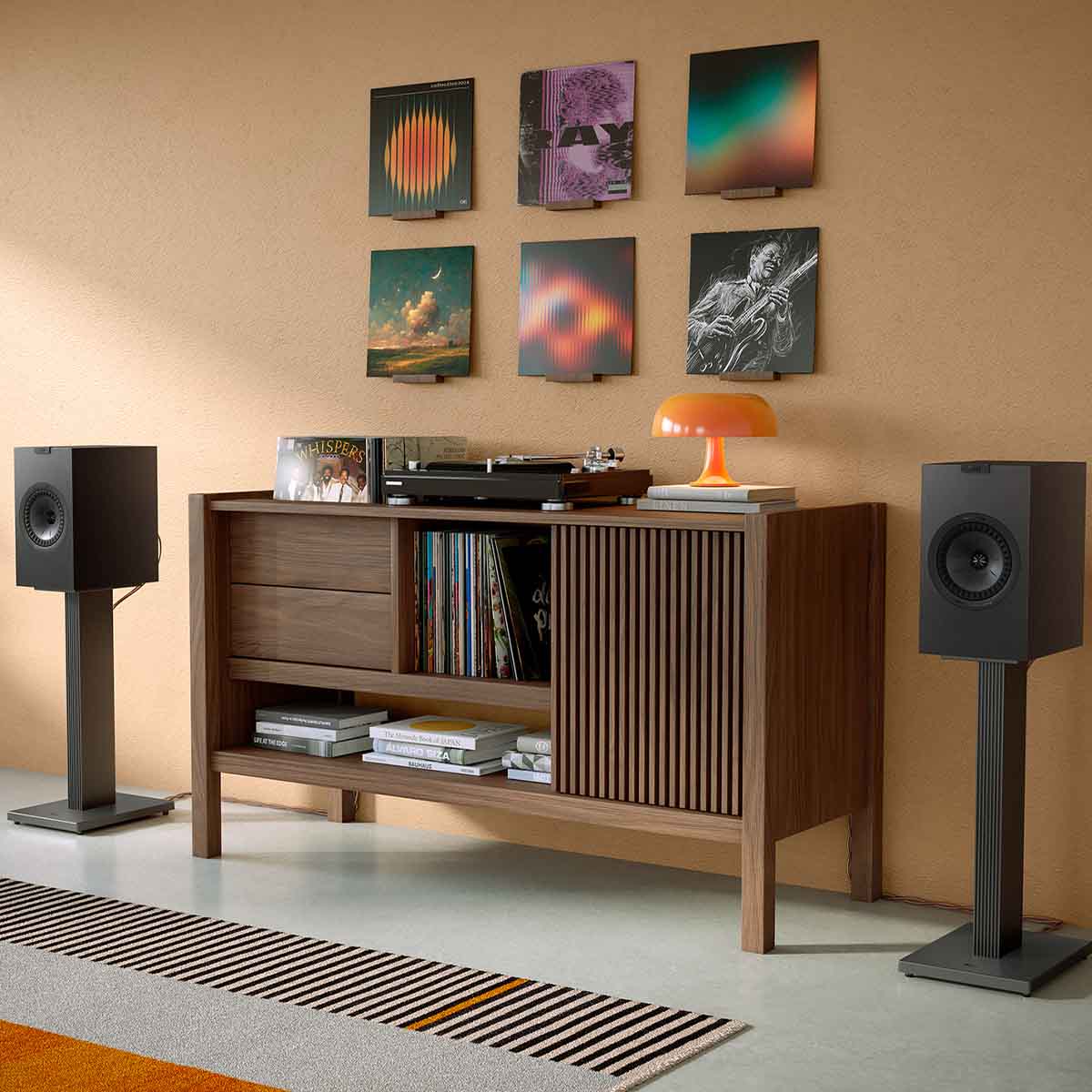 KEF Q3 Meta Bookshelf Speakers - Pair black pair on stands next to media console