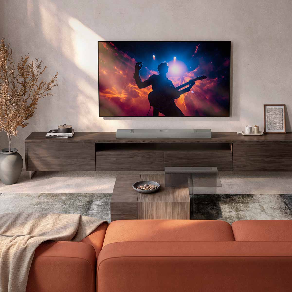 KEF XIO Soundbar - Silver Grey - lifestyle shot of unit flat on cabinet in front of TV