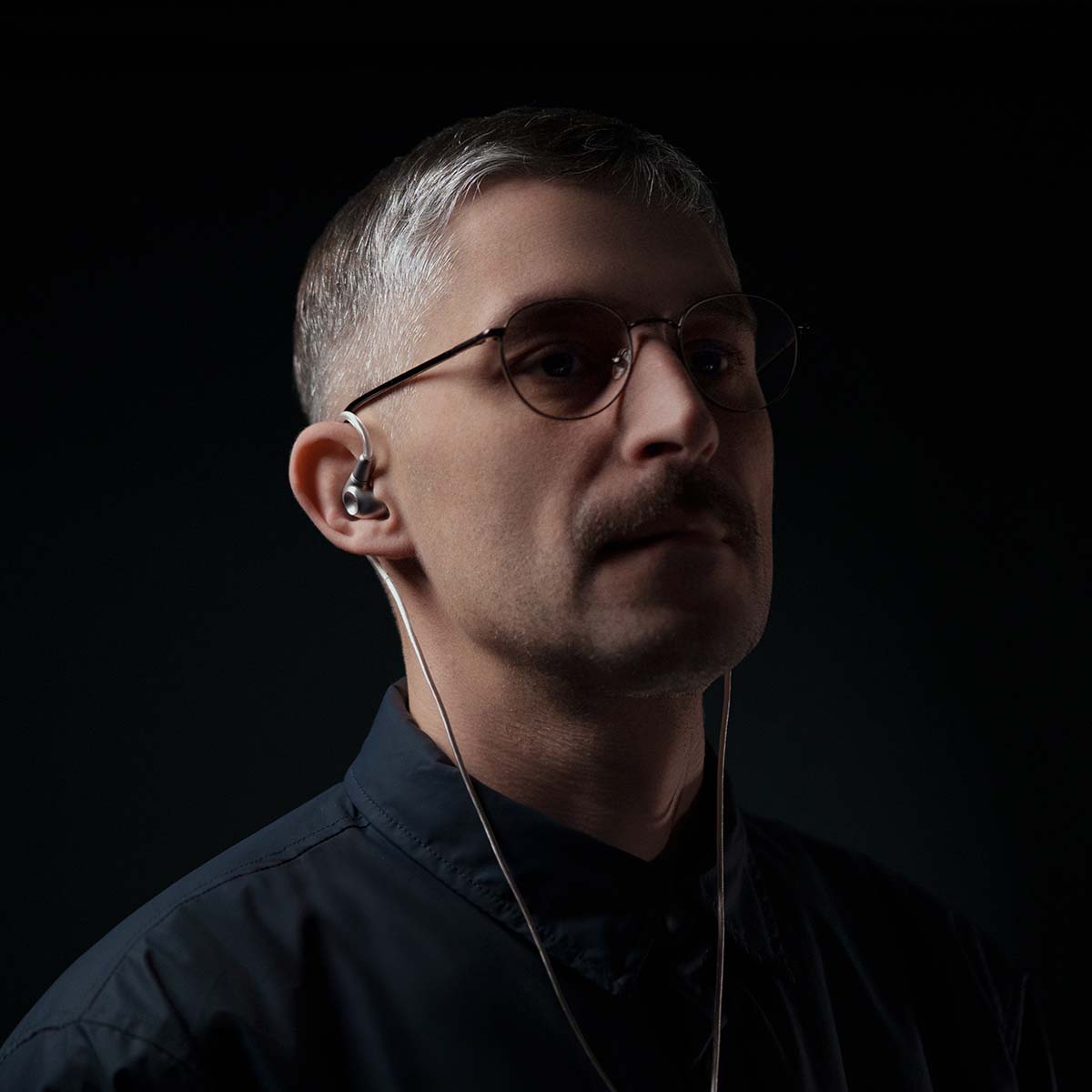 Meze Audio ASTRU Single Dynamic Driver In-Ear Monitors - man facing right wearing earbuds