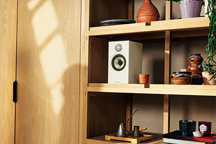 Bowers & Wilkins 607 S3 in white on a bookshelf