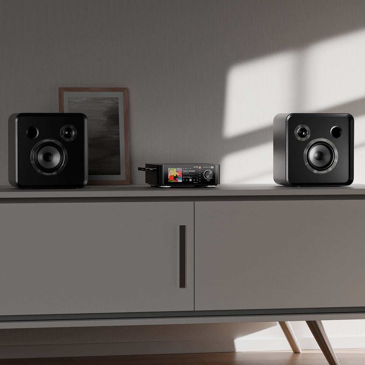 EverSolo SE100 Passive HiFi Bookshelf Speakers - Pair - lifestyle photo of speakers on cabinet surrounding amplifier
