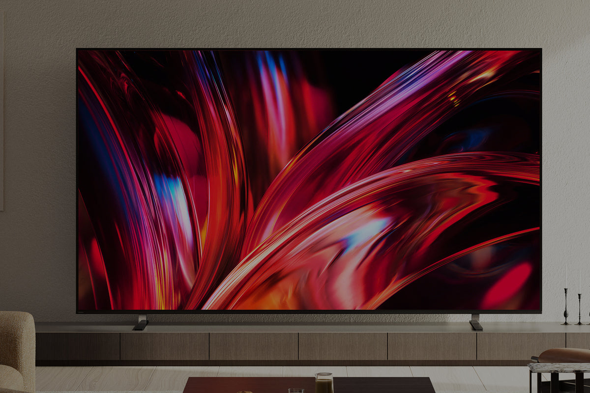 Large flat-screen TV displaying a colorful abstract design in a living room setting.