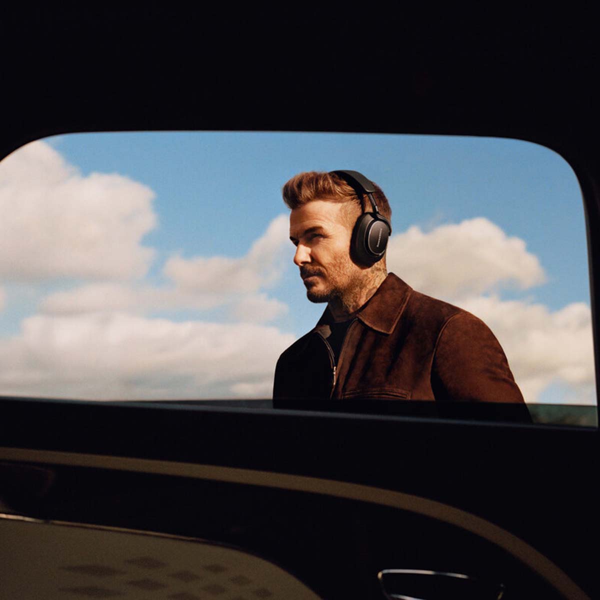 Bowers & Wilkins Px8 S2 Wireless Over-Ear Headphones - Lifestyle photo of David Beckham wearing Black pair
