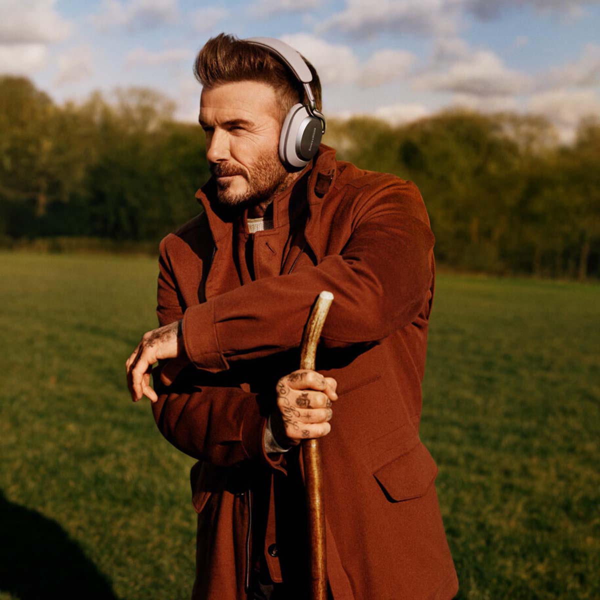 Bowers & Wilkins Px8 S2 Wireless Over-Ear Headphones - Lifestyle photo of David Beckham wearing Stone pair