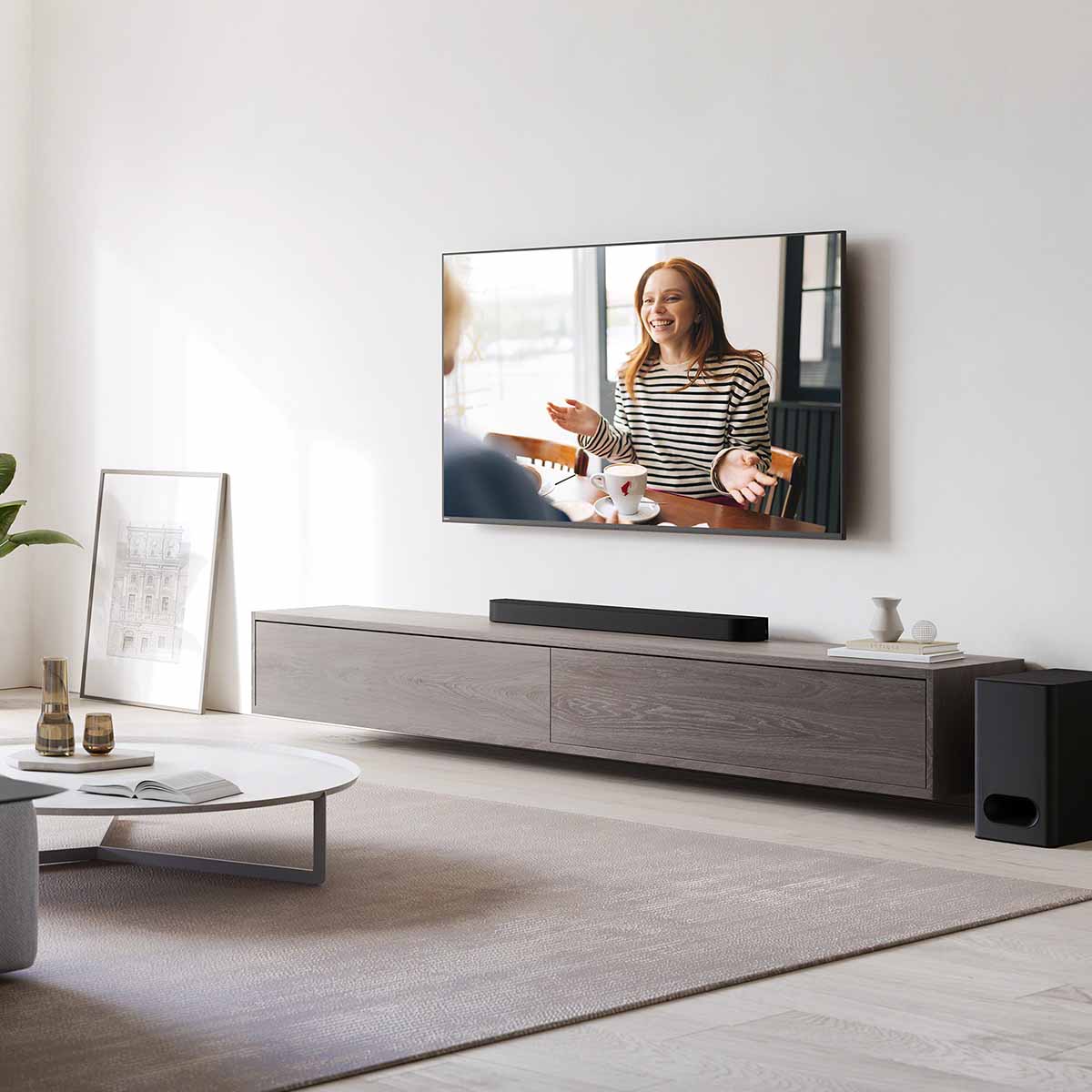 Lifestyle shot of Sony HT-B600 BRAVIA Theater Bar 6 3.1.2ch Soundbar with Wireless Subwoofer - bar on cabinet with subwoofer on ground to right