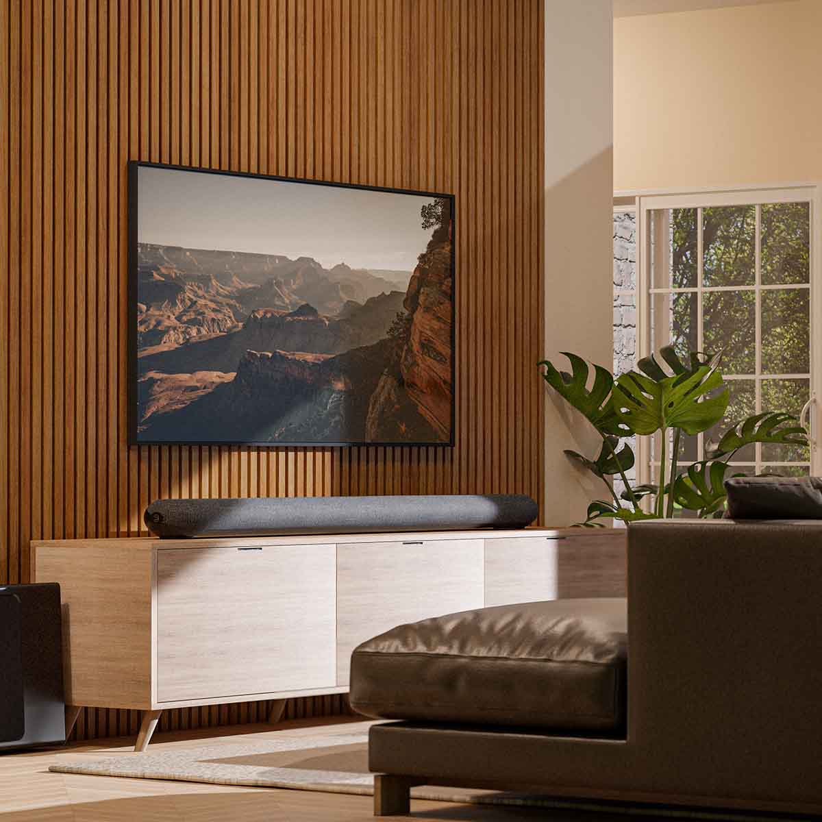 Bluesound Pulse Cinema Multi-Room Streaming Soundbar lifestyle photo of unit on cabinet under TV