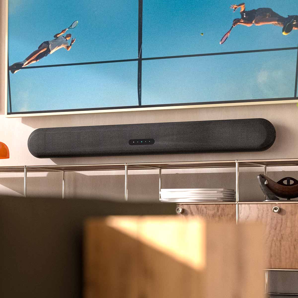 Bluesound Pulse Cinema Multi-Room Streaming Soundbar lifestyle photo of unit wall mounted under TV