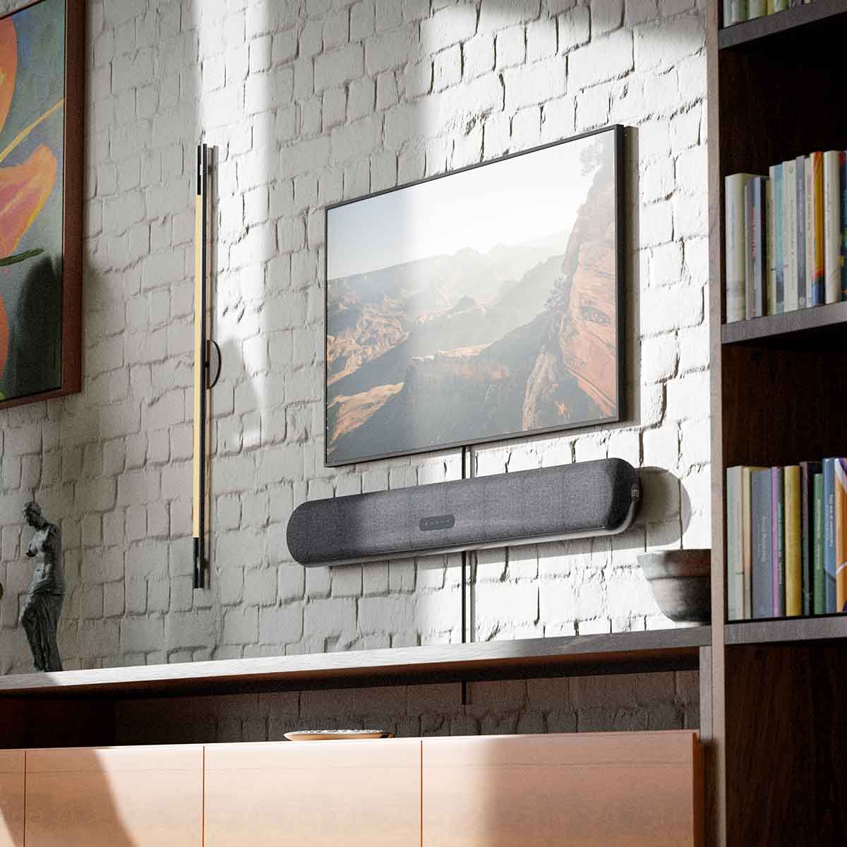 Bluesound Pulse Cinema Mini Multi-Room Streaming Soundbar Black lifestyle photo of unit wall mounted below TV