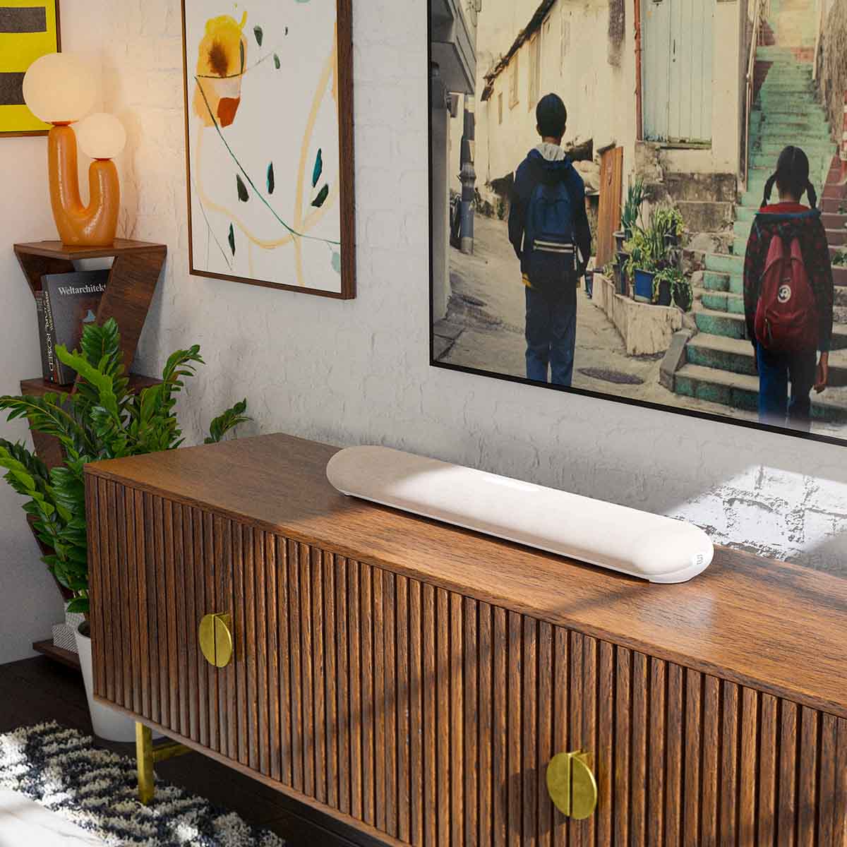 Bluesound Pulse Cinema Mini Multi-Room Streaming Soundbar Tan lifestyle photo of unit on cabinet below TV