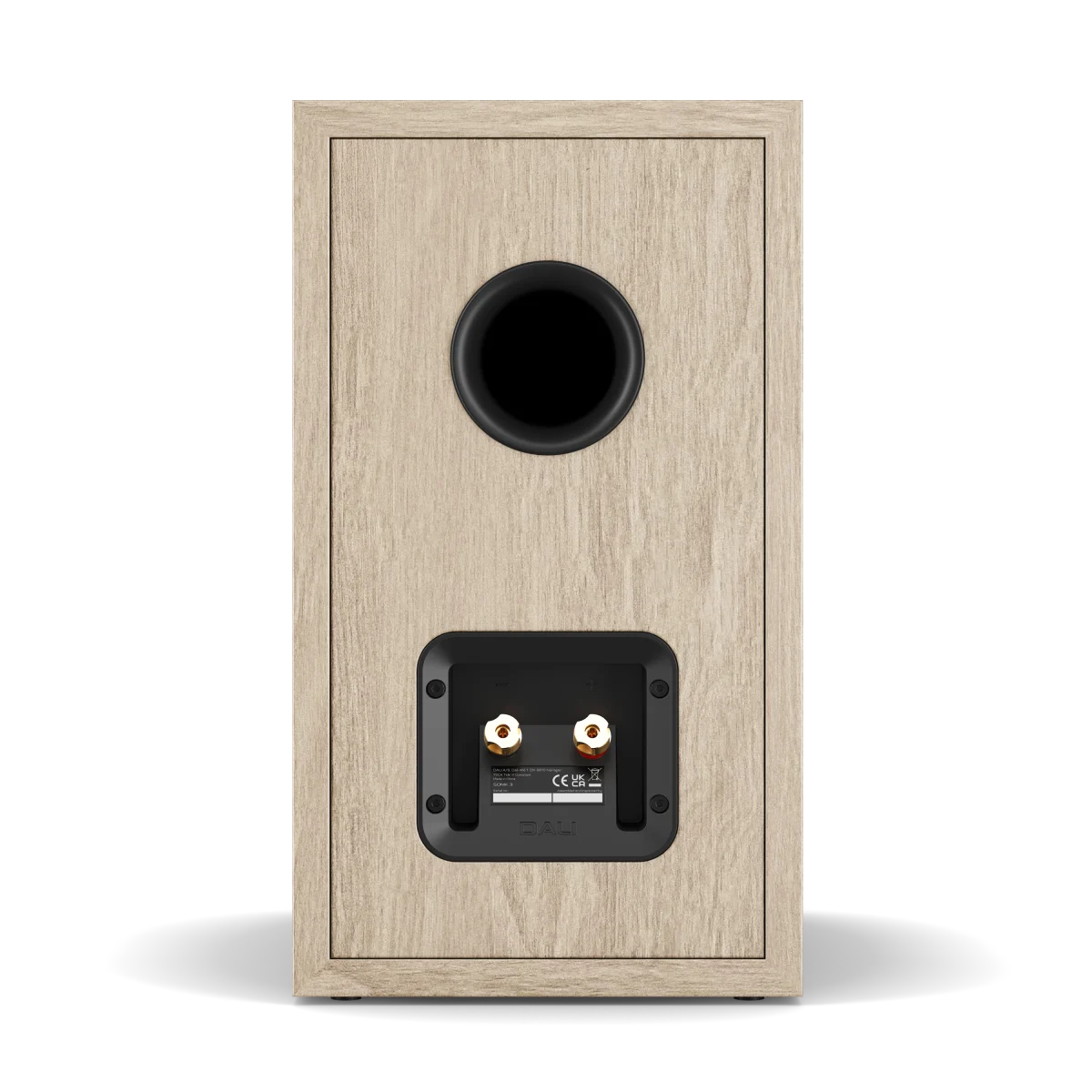 A single bookshelf speaker shown from the rear, featuring a light oak wood-grain finish and a black circular port and rear terminal plate, set against a plain white background.