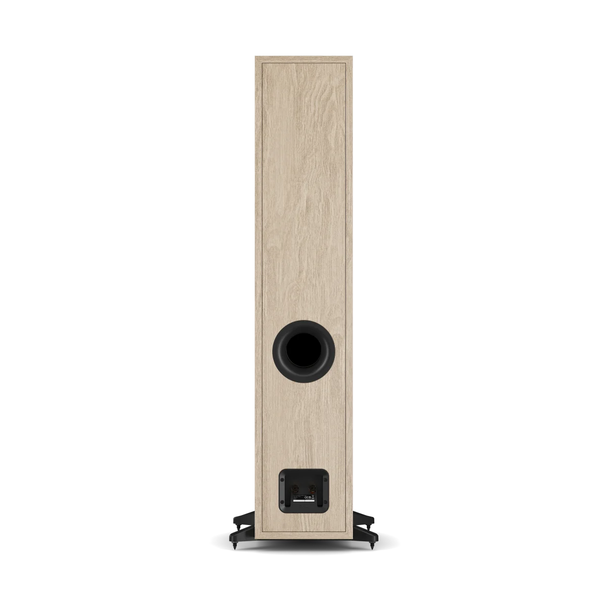 A tall, narrow Dali Sonik 7 floor-standing speaker with a light oak wood-grain finish and a black circular driver and front baffle, shown from the back on a white background.