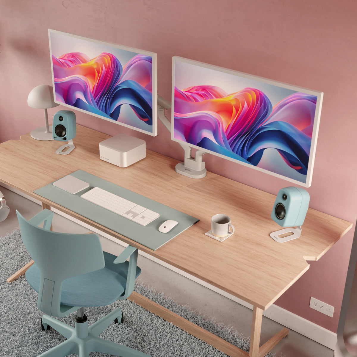Modern home office setup with dual monitors, desk, chair, and coffee cup.