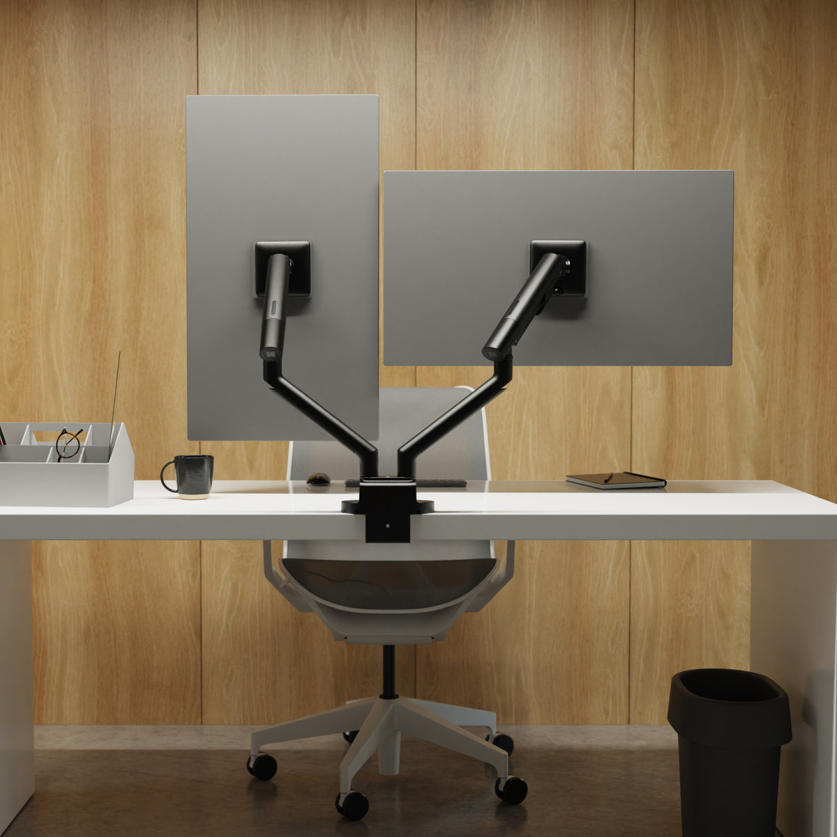 Modern office setup with a desk, chair, and adjustable screen divides against a wooden wall.