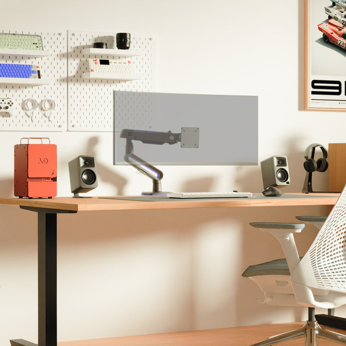 Modern office desk setup with computer monitor, speakers, and chair.