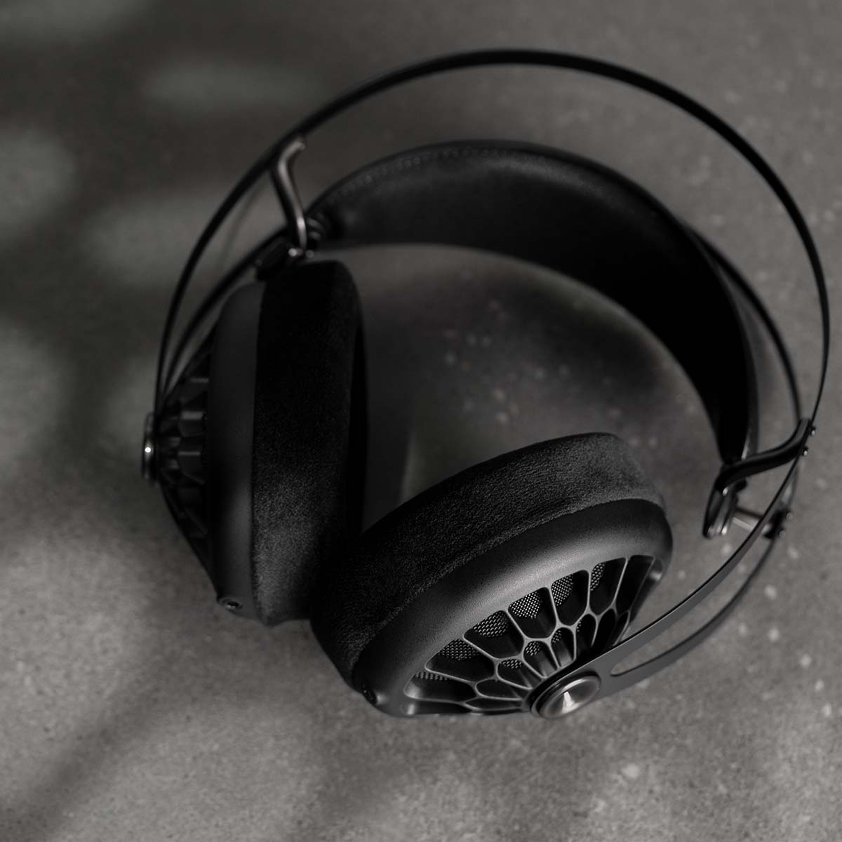Meze 105 AER Open-Back Headphones - black laying on stone counter top-down