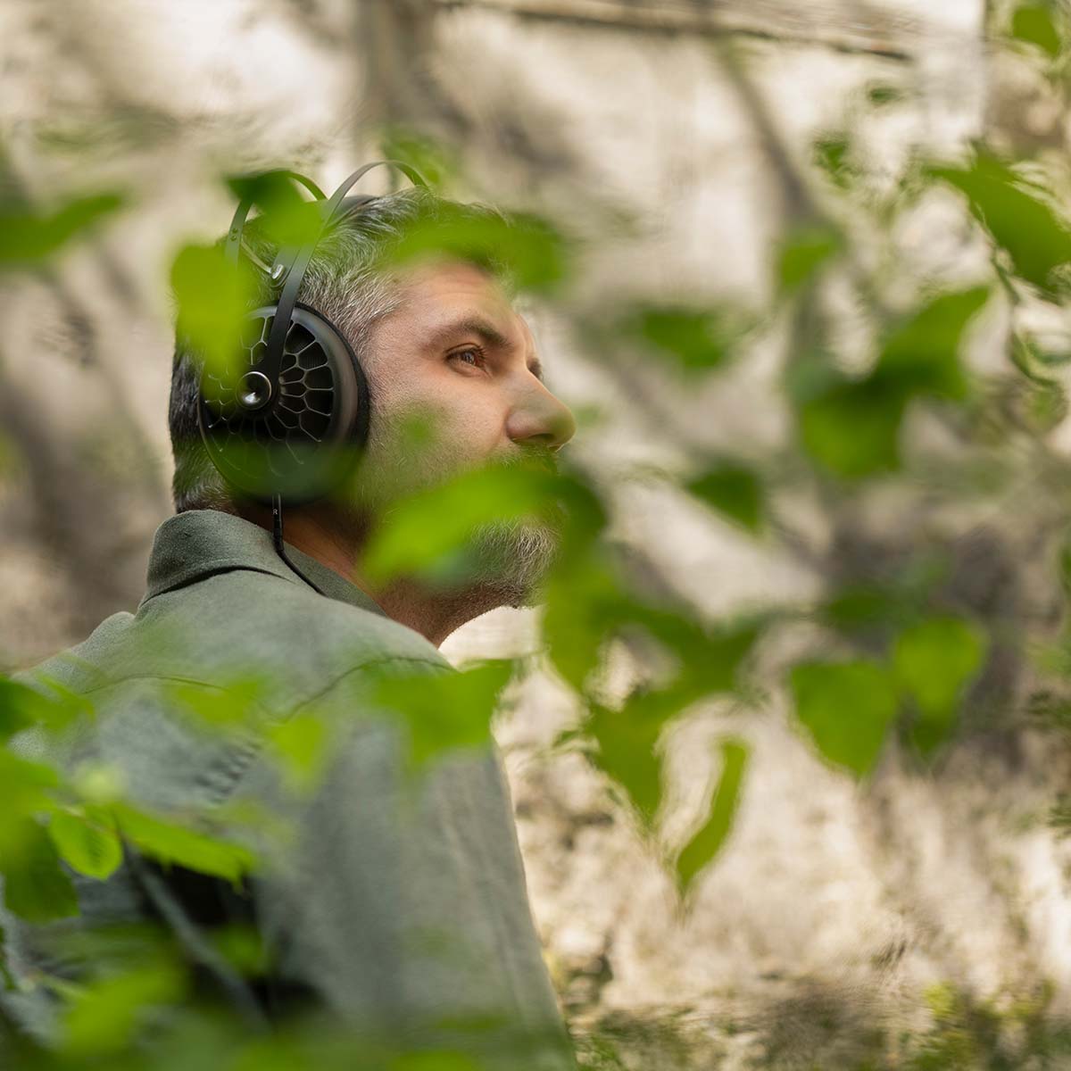 Meze 105 AER Open-Back Headphones - black lifestyle shot side view man wearing headphones in nature