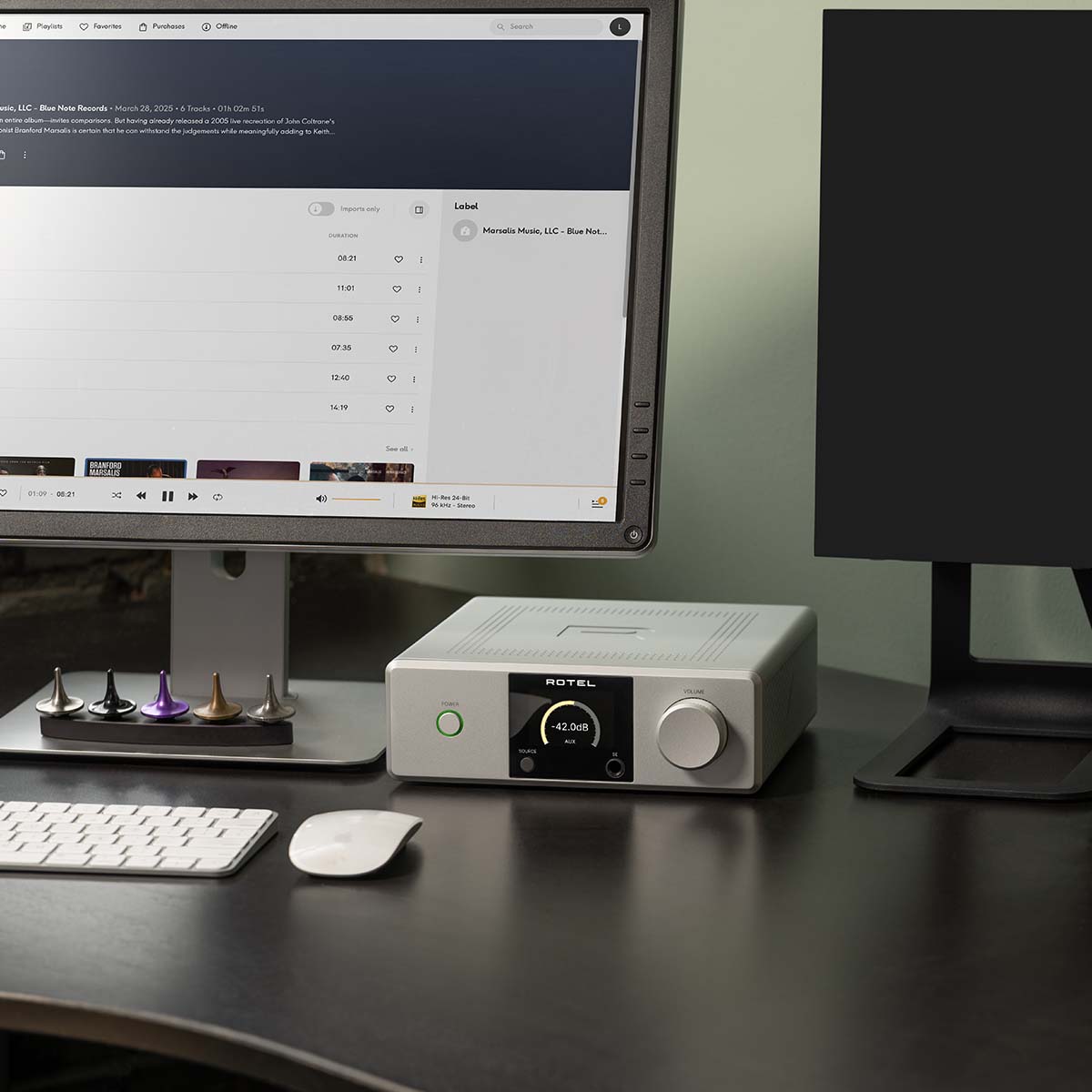 Lifestyle photo Rotel DX-5 Integrated Amplifier - silver front view to right of desktop computer