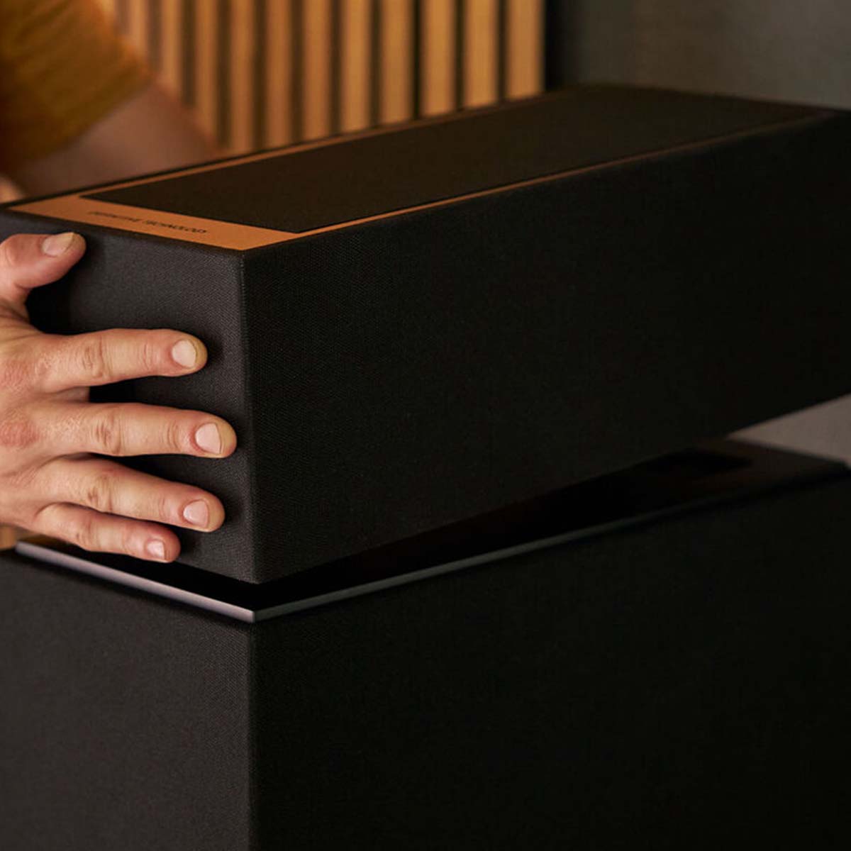 Definitive Technology Dymension DM90 Integrated Height Module for Dymension DM80 and DM70 - Pair being placed on top of tower speaker