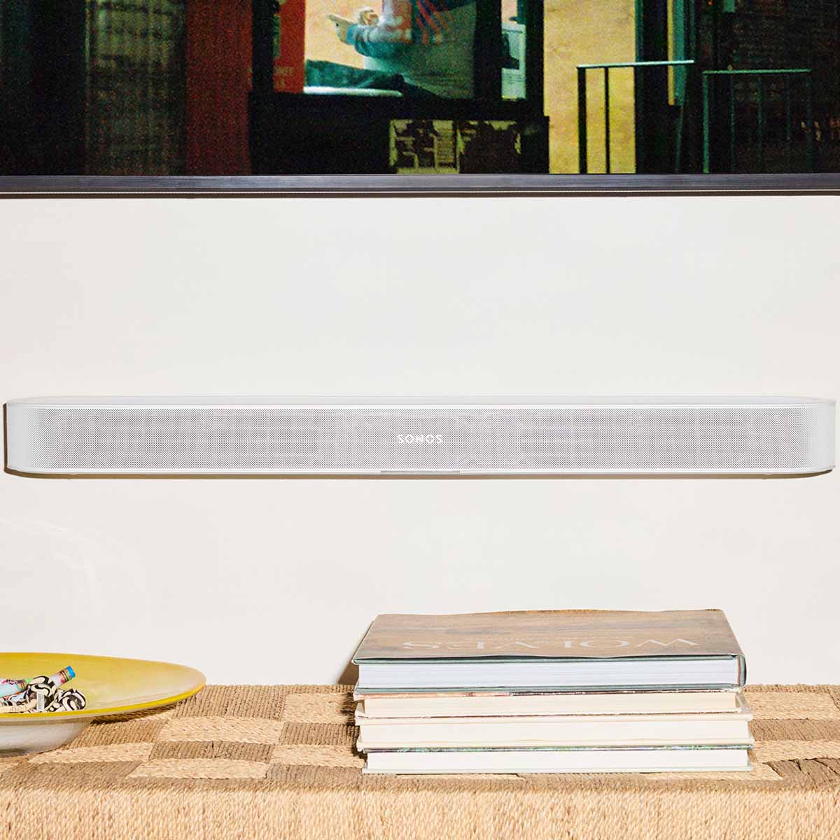 Sonos Beam Ultra Soundbar - lifestyle photo of black soundbar mounted on a wall below a TV