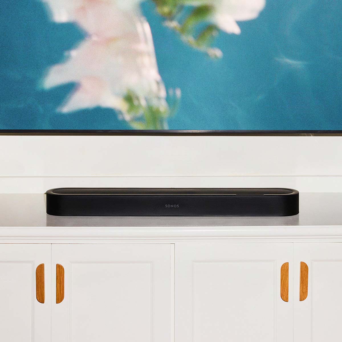 Sonos Beam Ultra Soundbar - lifestyle photo of black soundbar on a cabinet in a living room