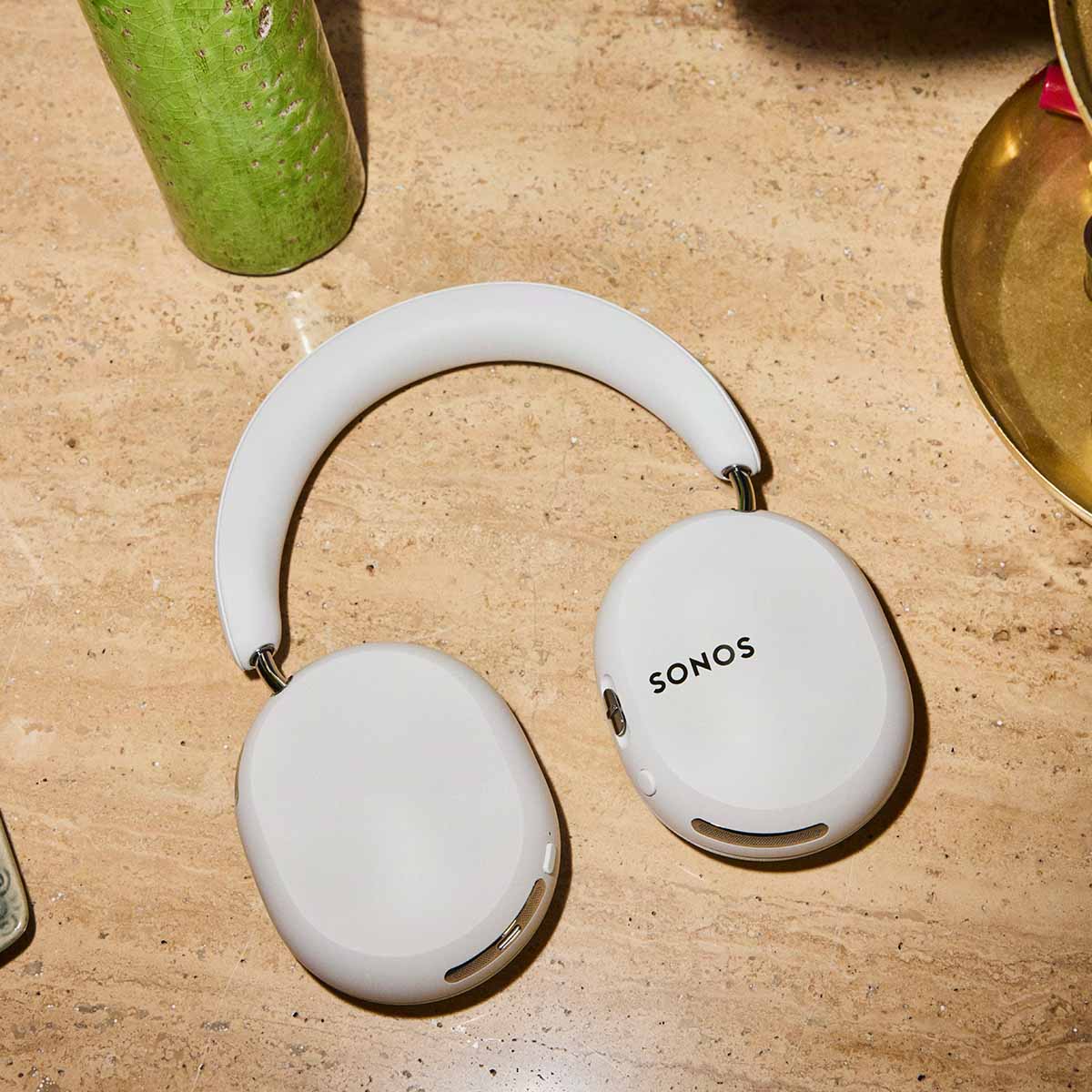 Sonos Ace Ultra Wireless Over-Ear Headphones - lifestyle photo of white headphones on a stone countertop