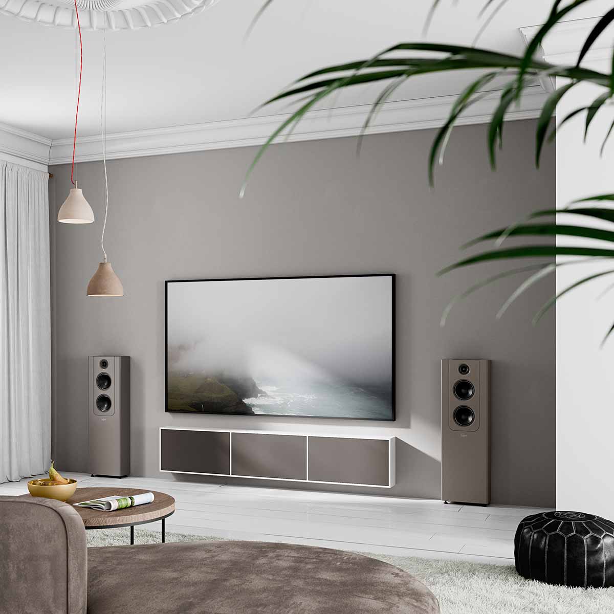 Lyngdorf FR-2 Speaker - lifestyle shot of mocca speakers with mocca baffles on floor next to wall