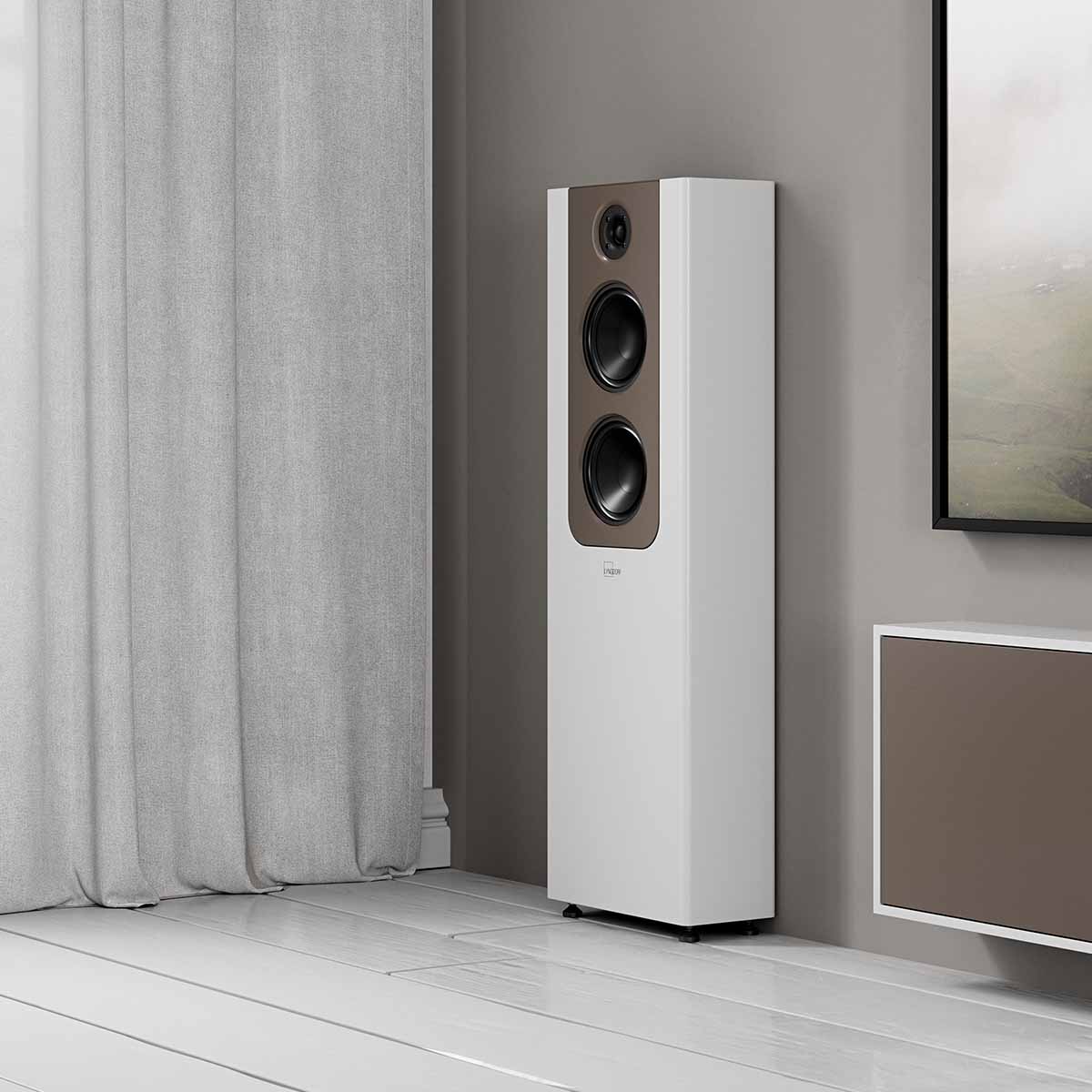 Lyngdorf FR-2 Speaker - lifestyle shot of single white speaker with mocca baffle on floor