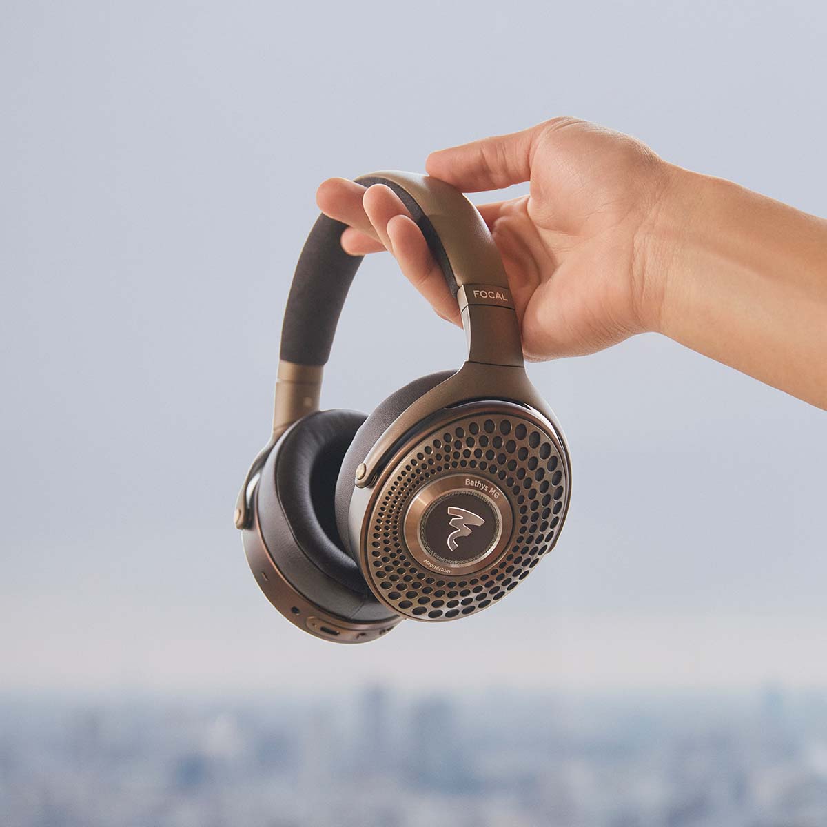 Focal Bathys MG Wireless Over-Ear Active Noise Cancelling Headphones - lifestyle shot of hand holding headphones