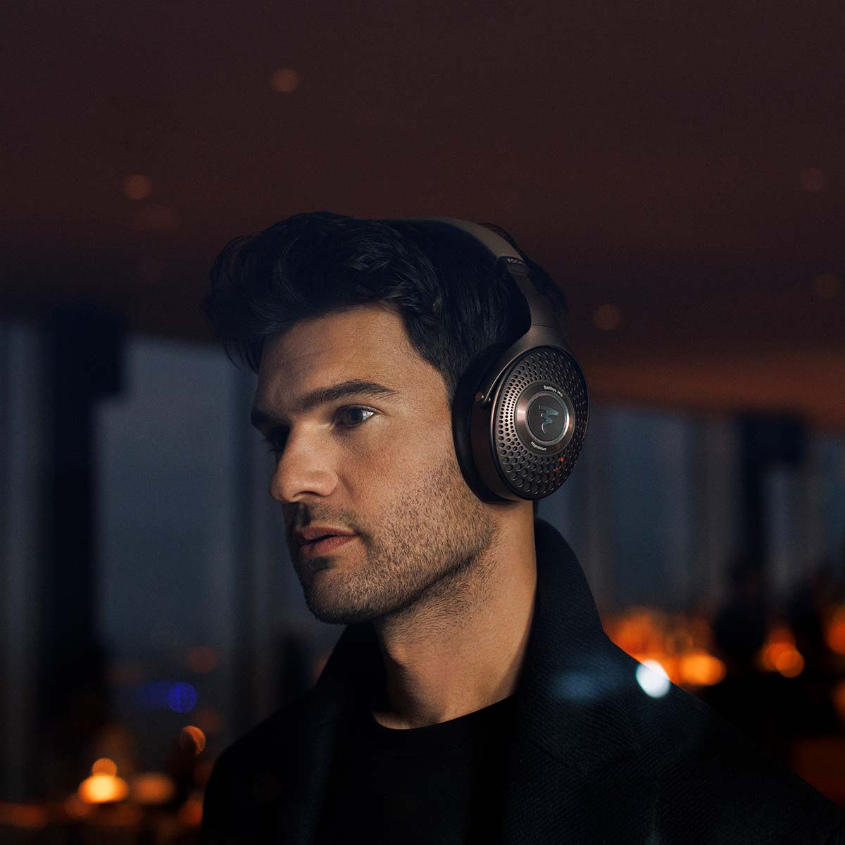 Focal Bathys MG Wireless Over-Ear Active Noise Cancelling Headphones - lifestyle shot close-up of man wearing headphones at night