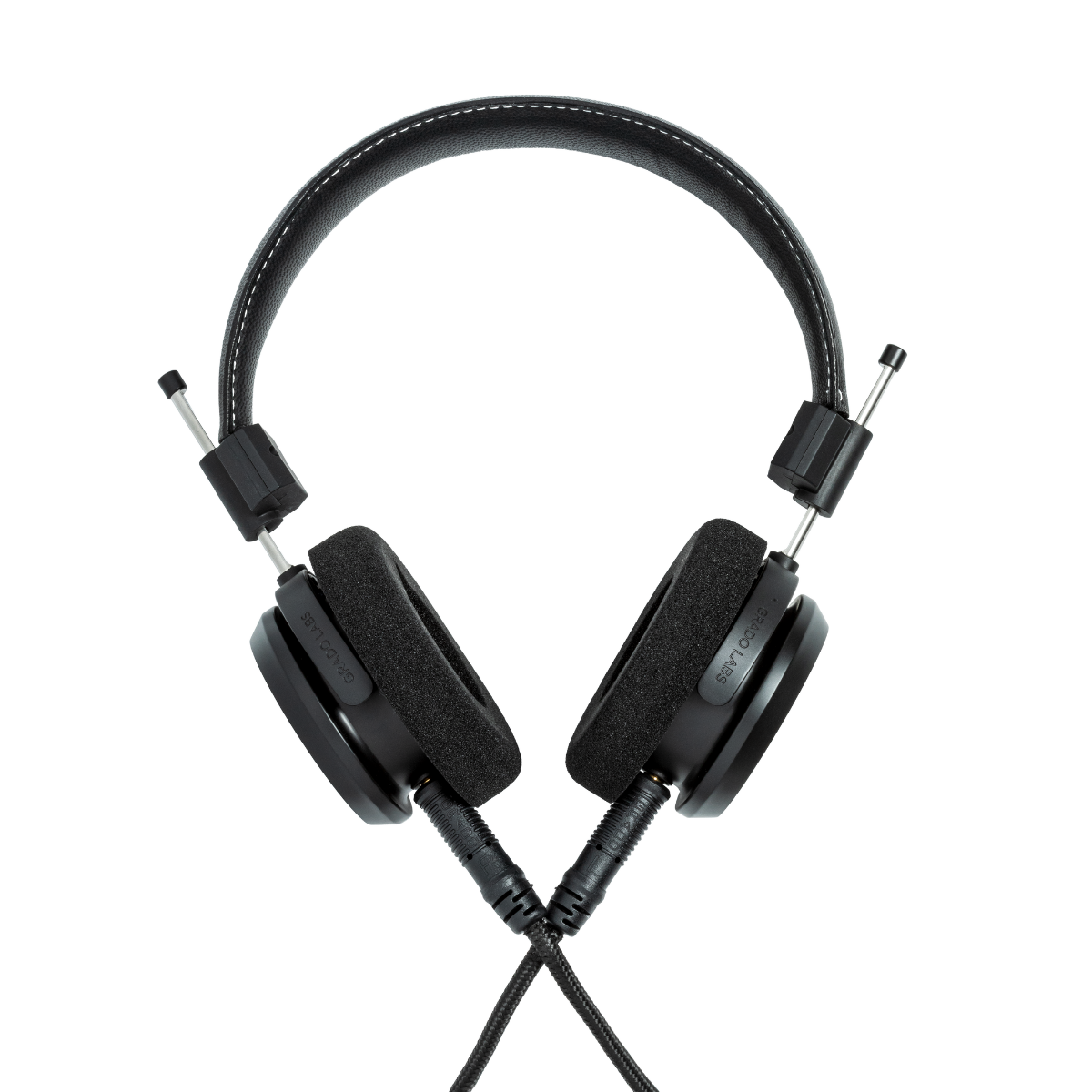 Black over-ear wired headphones with padded ear cups, a padded headband, and visible silver metal connector tips on a plain white background.