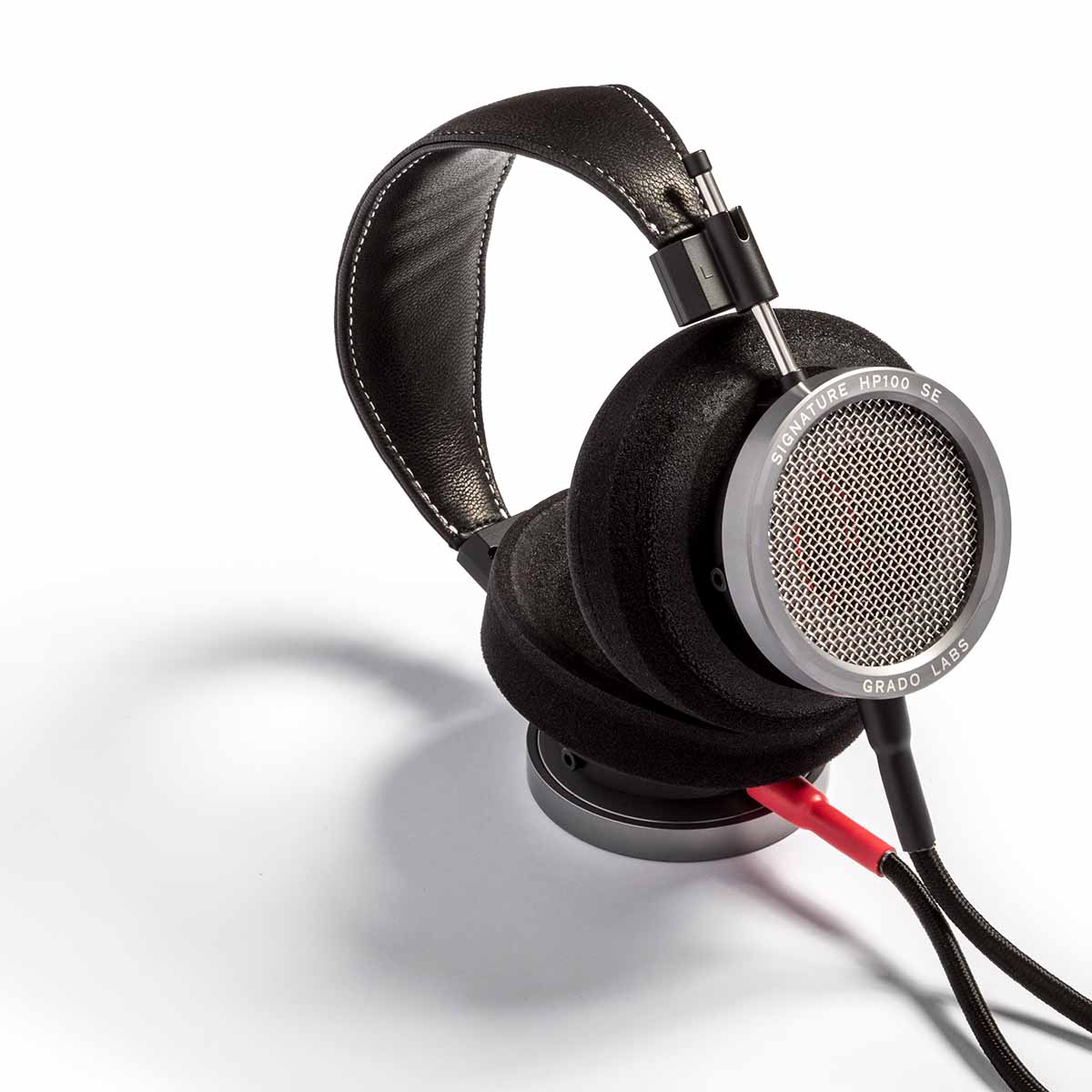 Grado Signature HP100 SE Headphones laying on side angled left with cable connected