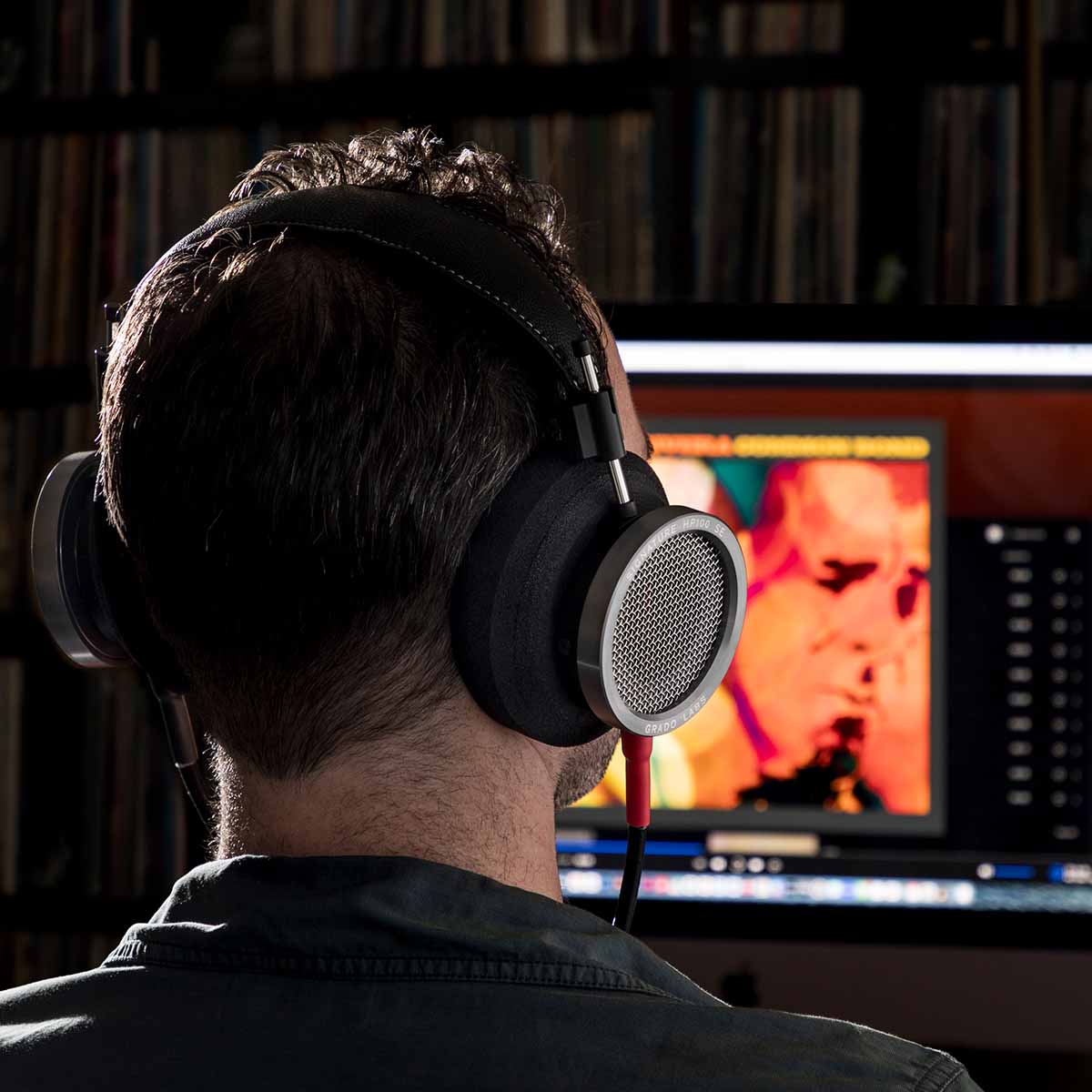 Grado Signature HP100 SE Headphones lifestyle shot man wearing headphones facing away three-quarter view