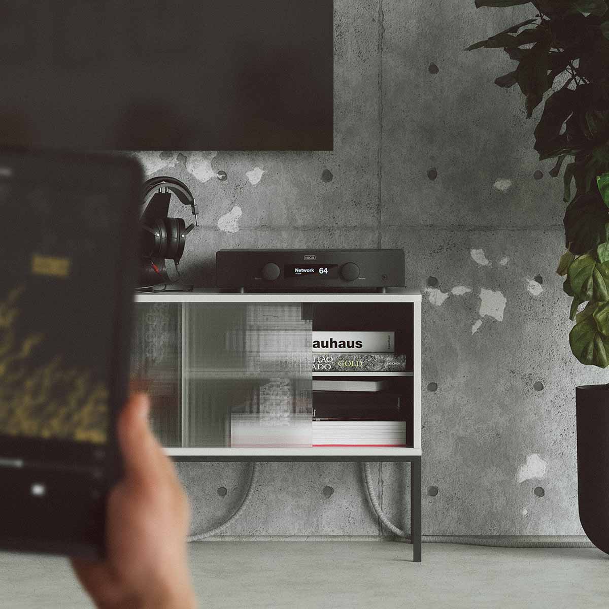 Hegel H95 Integrated Amplifier front view lifestyle shot of unit on cabinet