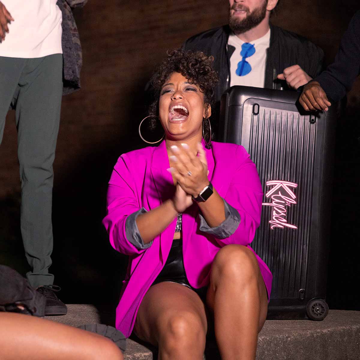 Klipsch New York Music City Series Ultimate Party Speaker lifestyle shot behind woman in purple jacket showing Klipsch logo