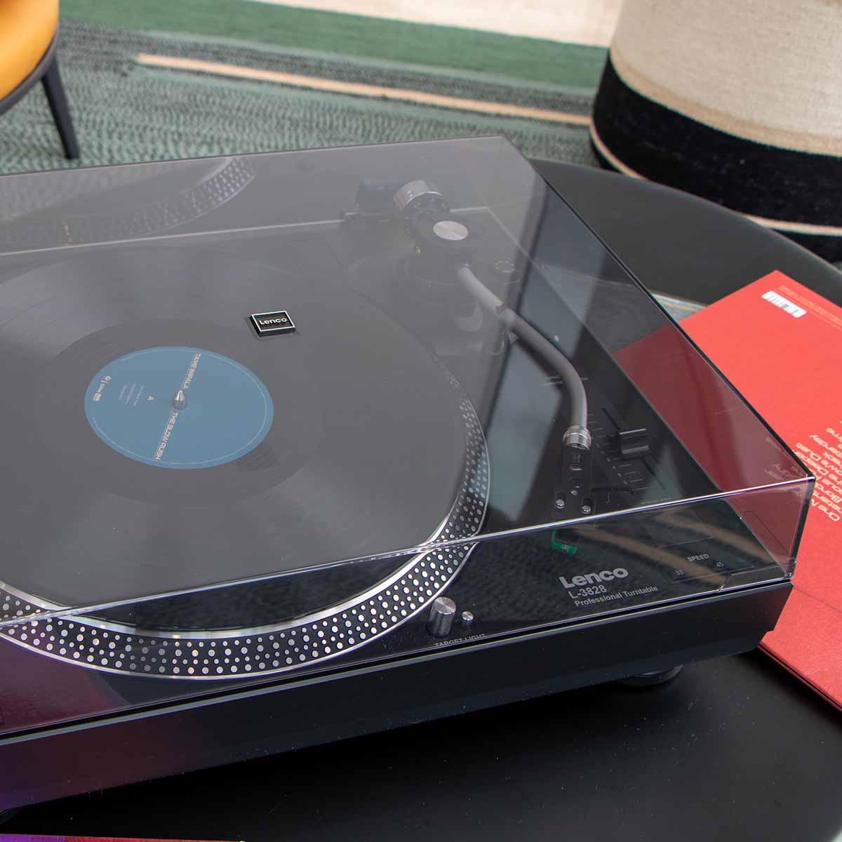Lenco L-3828 Direct Drive Turntable high angle side view lifestyle shot with closed dustcover