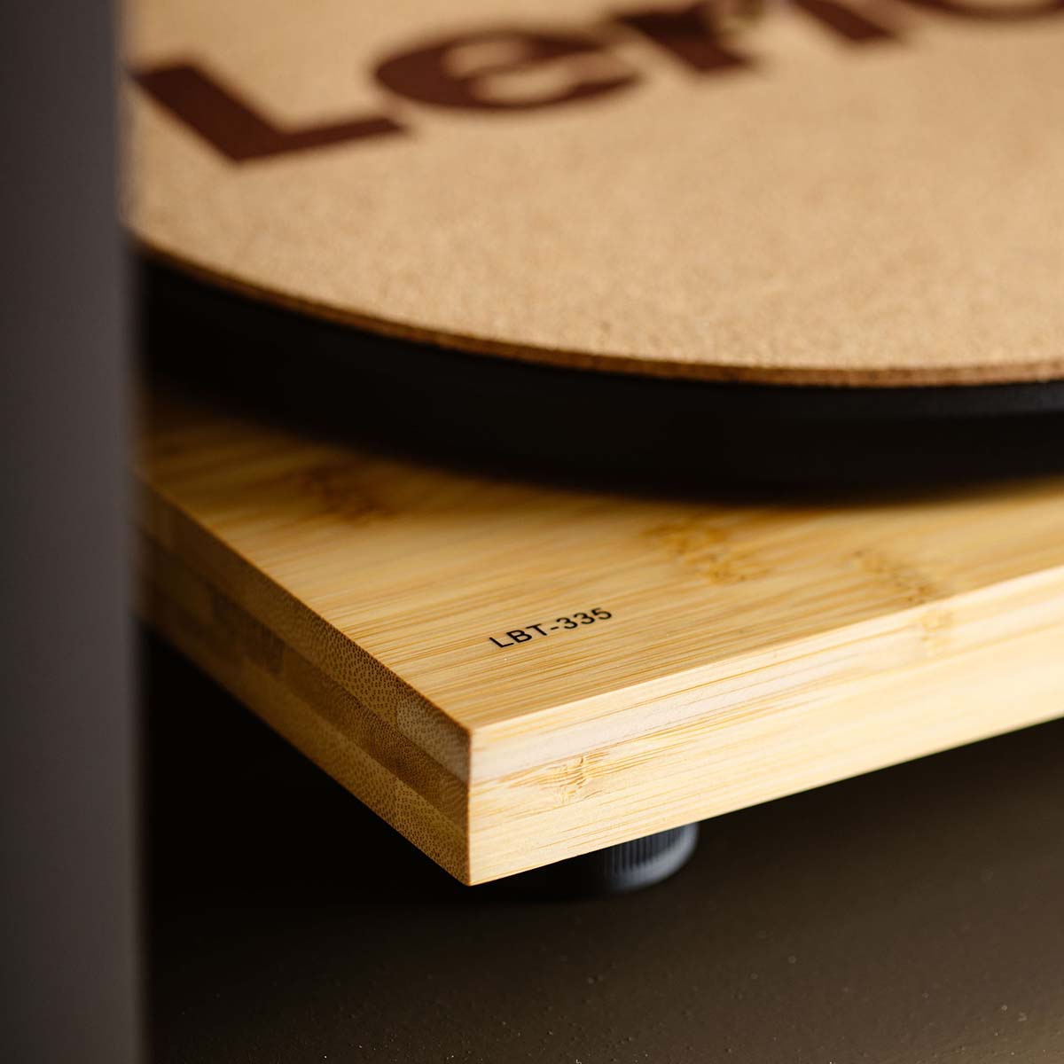 Lenco LBT-335 Bluetooth Turntable w/ Ortofon 2M Red Cartridge lifestyle photo closeup of LBT-335 branding on front left corner of unit