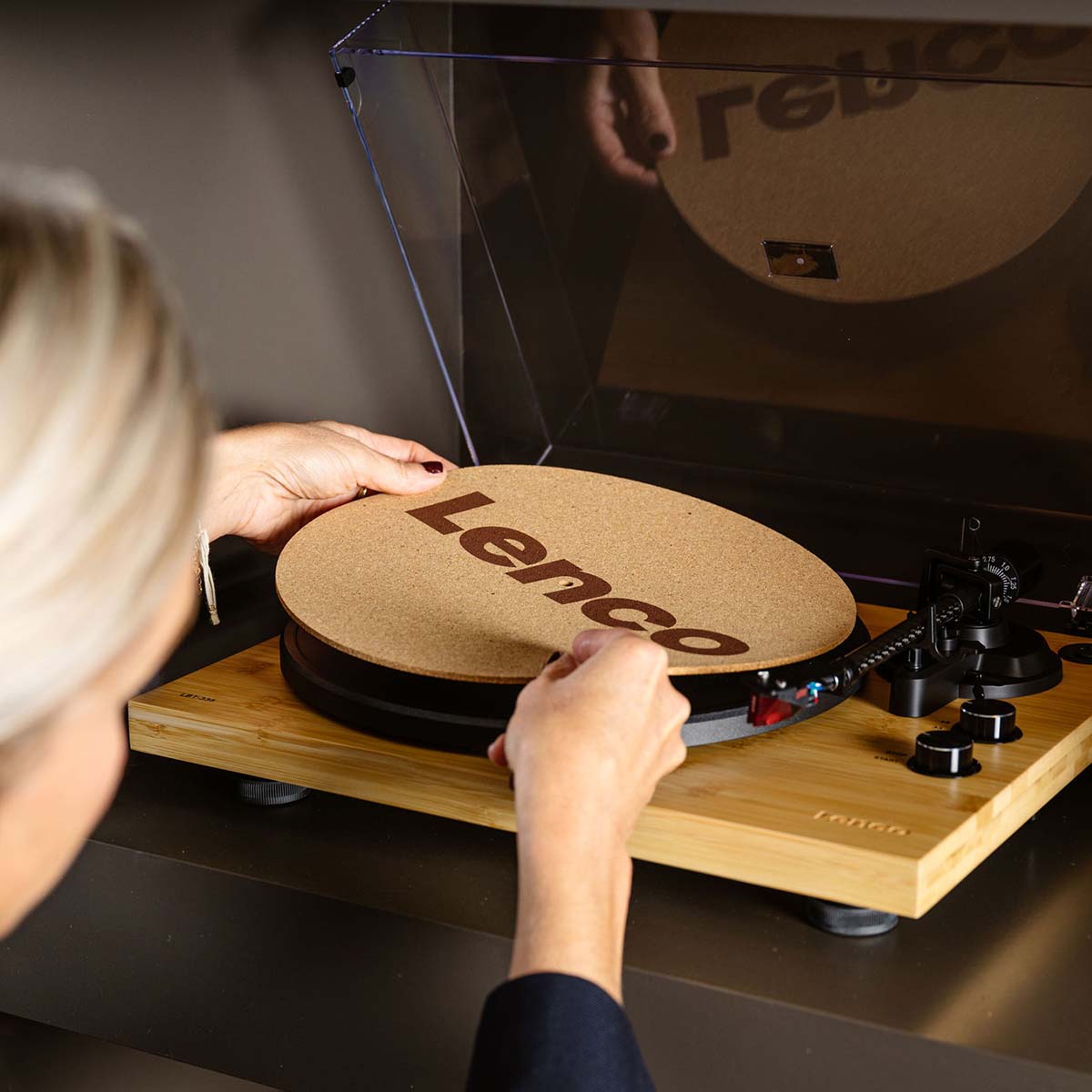 Lenco LBT-335 Bluetooth Turntable w/ Ortofon 2M Red Cartridge lifestyle photo of woman removing cork mat from turntable