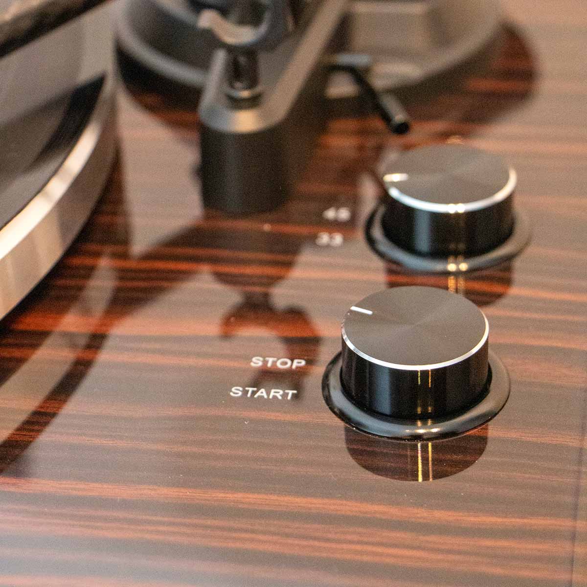 Lenco LBT-345 Bluetooth Turntable w/ Ortofon 2M Red closeup of control knobs angled down and left with open dustcover