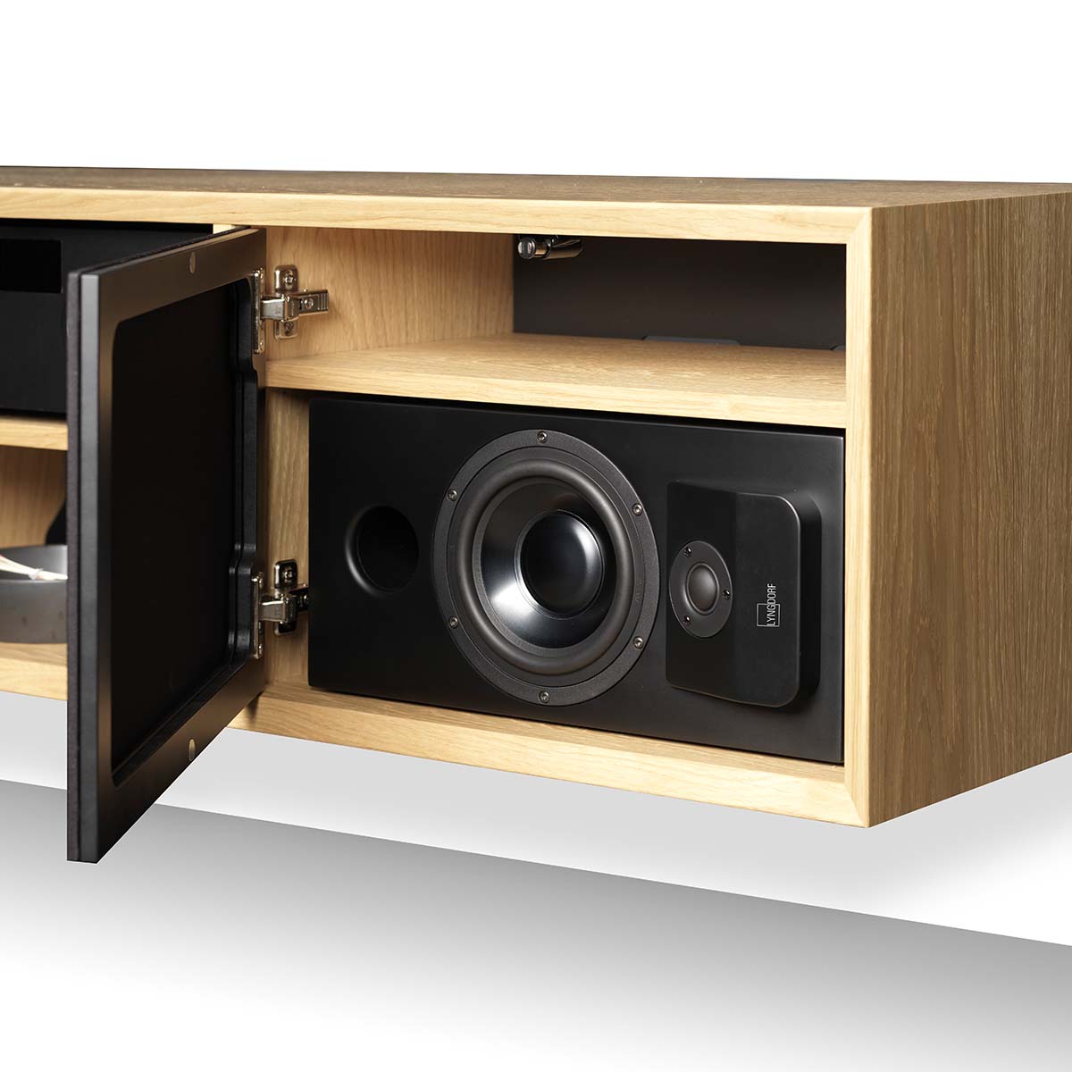 Lyngdorf CS-1 Speaker lifestyle shot of speaker in cabinet with door grille open