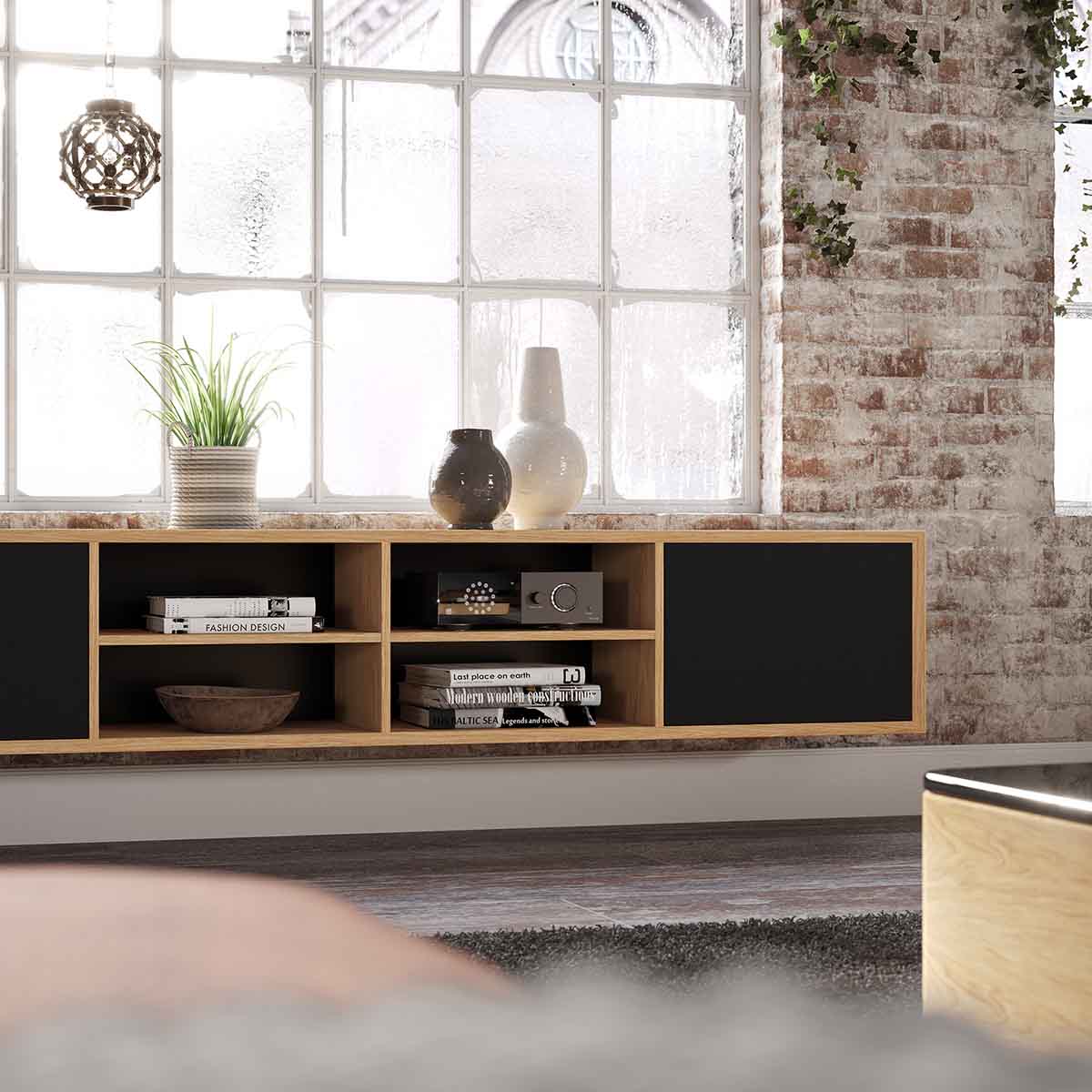 Lyngdorf CS-1 Speaker lifestyle shot of speaker in cabinet with door grille closed