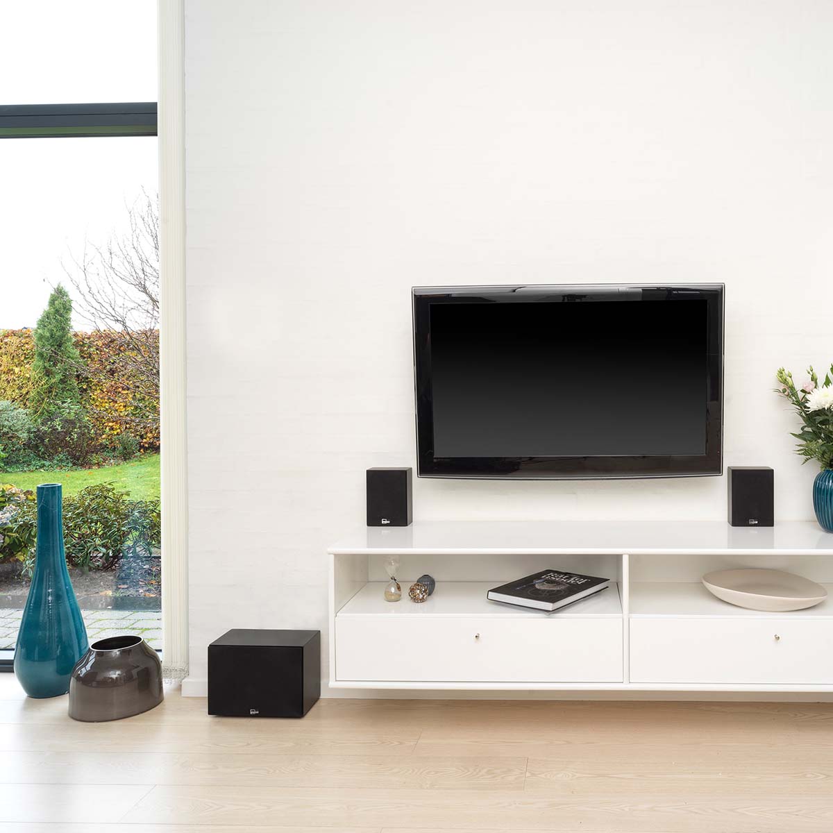Lyngdorf BW-3 Black Audiophile Subwoofer lifestyle shot of unit to left of cabinet