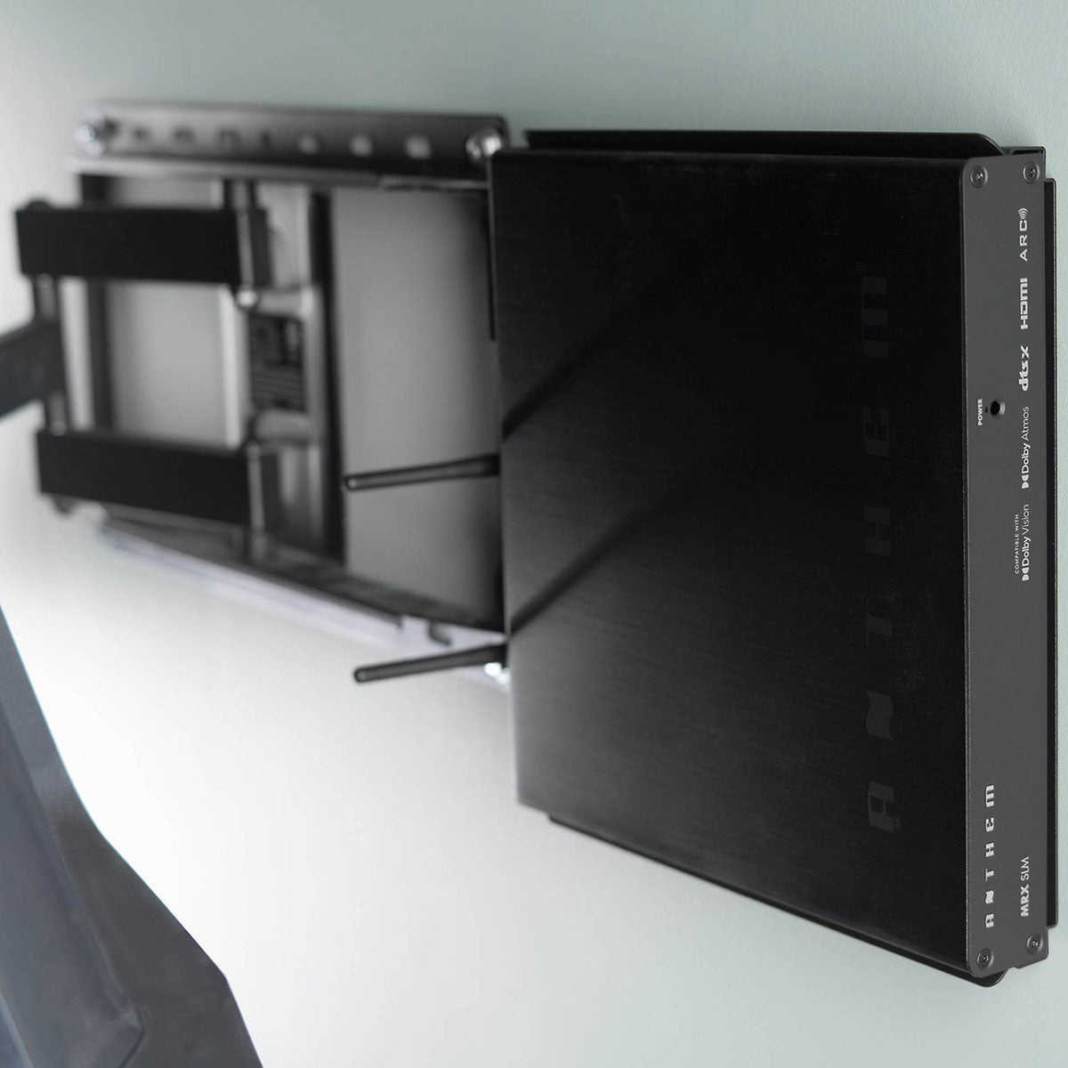 Anthem MRX SLM Compact AVR mounted on wall behind TV