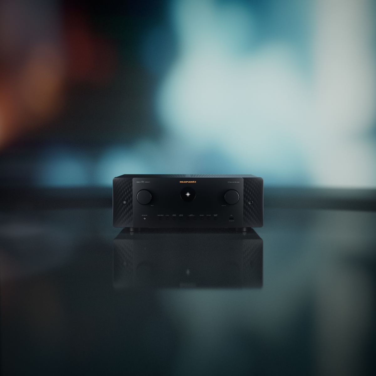 A black Marantz Cinema 60 Series 2 AV Receiver sitting on a reflective dark surface with a blurred blue-toned background.