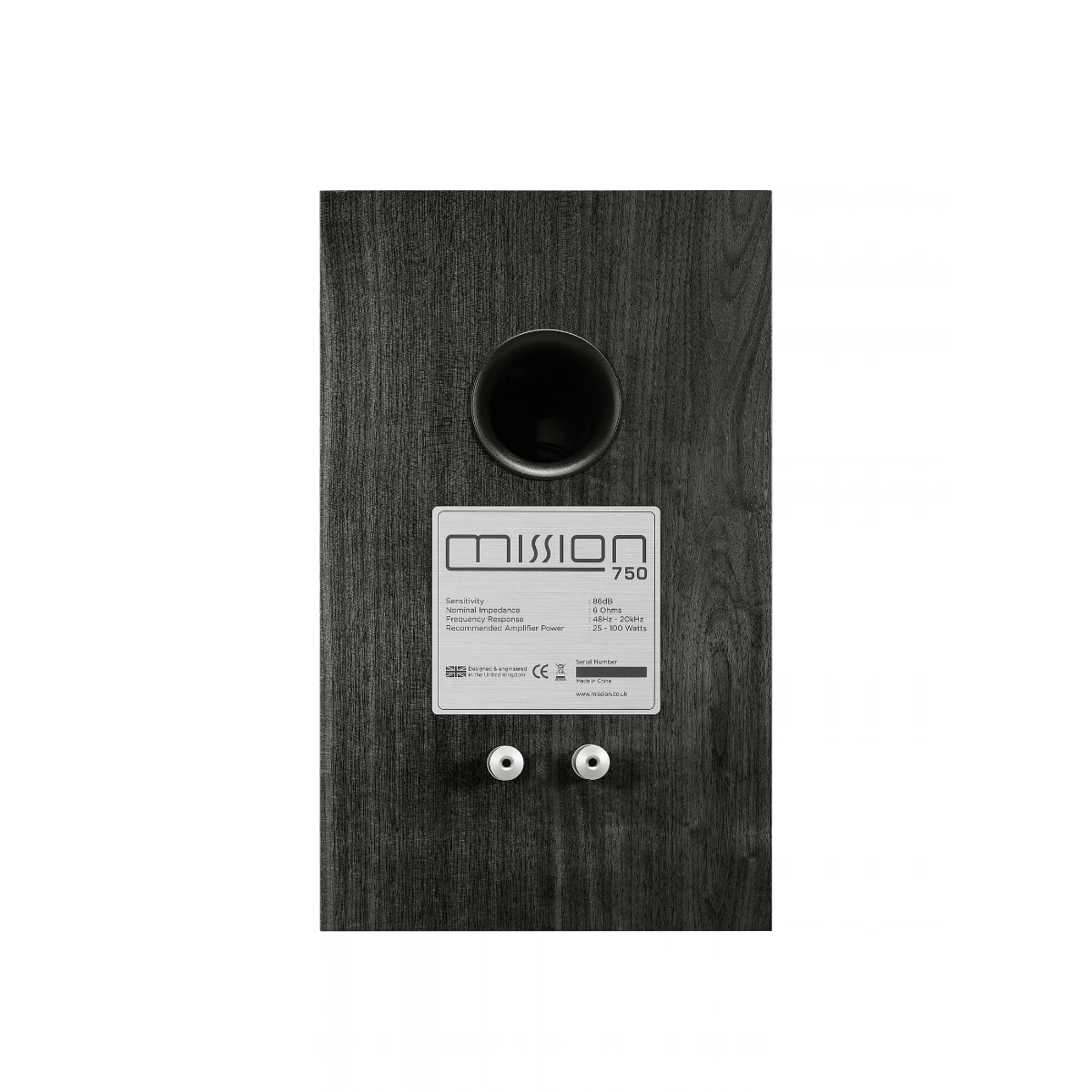 The rear view of a Mission 750 bookshelf speaker, featuring a dark wood-grain finish, a circular port, and a white product label with two terminal screws.