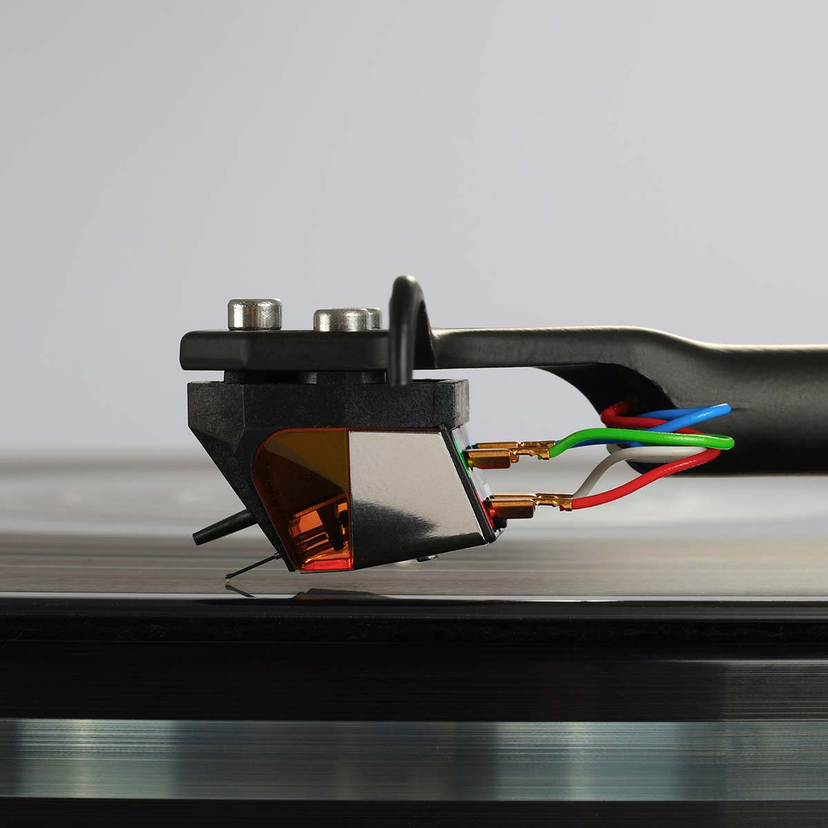 Rega ND9 Moving Magnet Phono Cartridge - side view of cartridge mounted on tone arm with needle on record