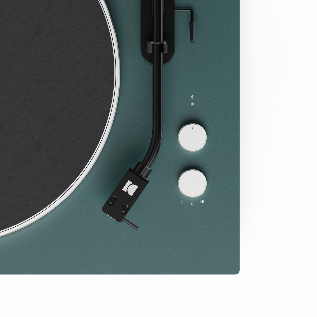 Close-up of a turntable with a green base and white control knobs on a white background