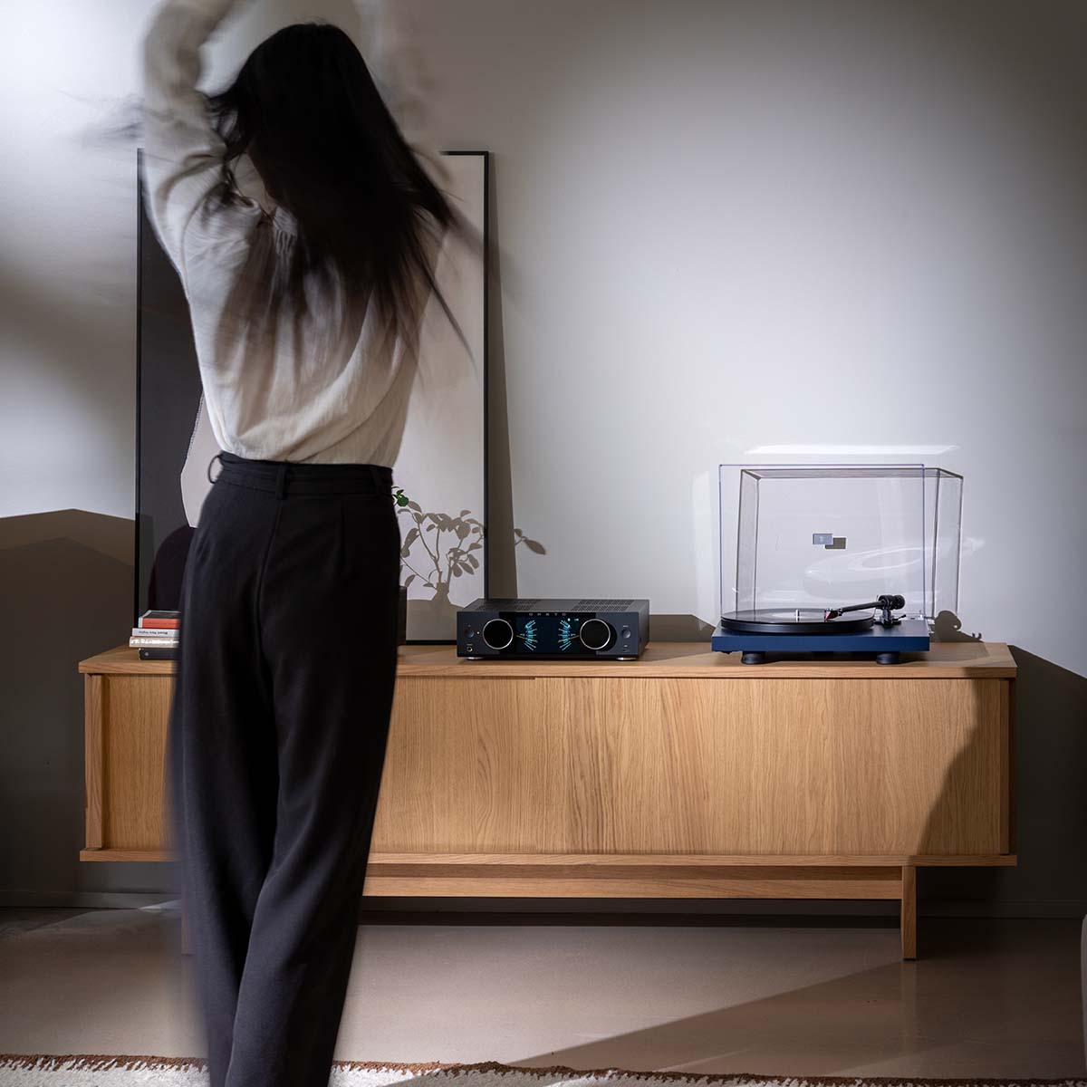 Onkyo Muse Y-40 Network Integrated Amplifier - Black - lifestyle photo of unit on cabinet with dancing woman in foreground